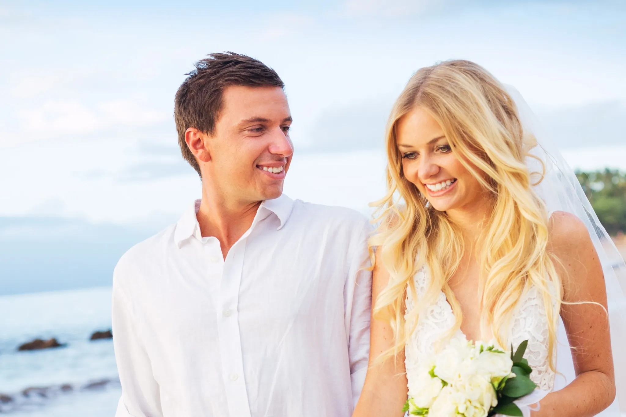 A bride and groom walking on a beach, after getting married in Costa Rica.