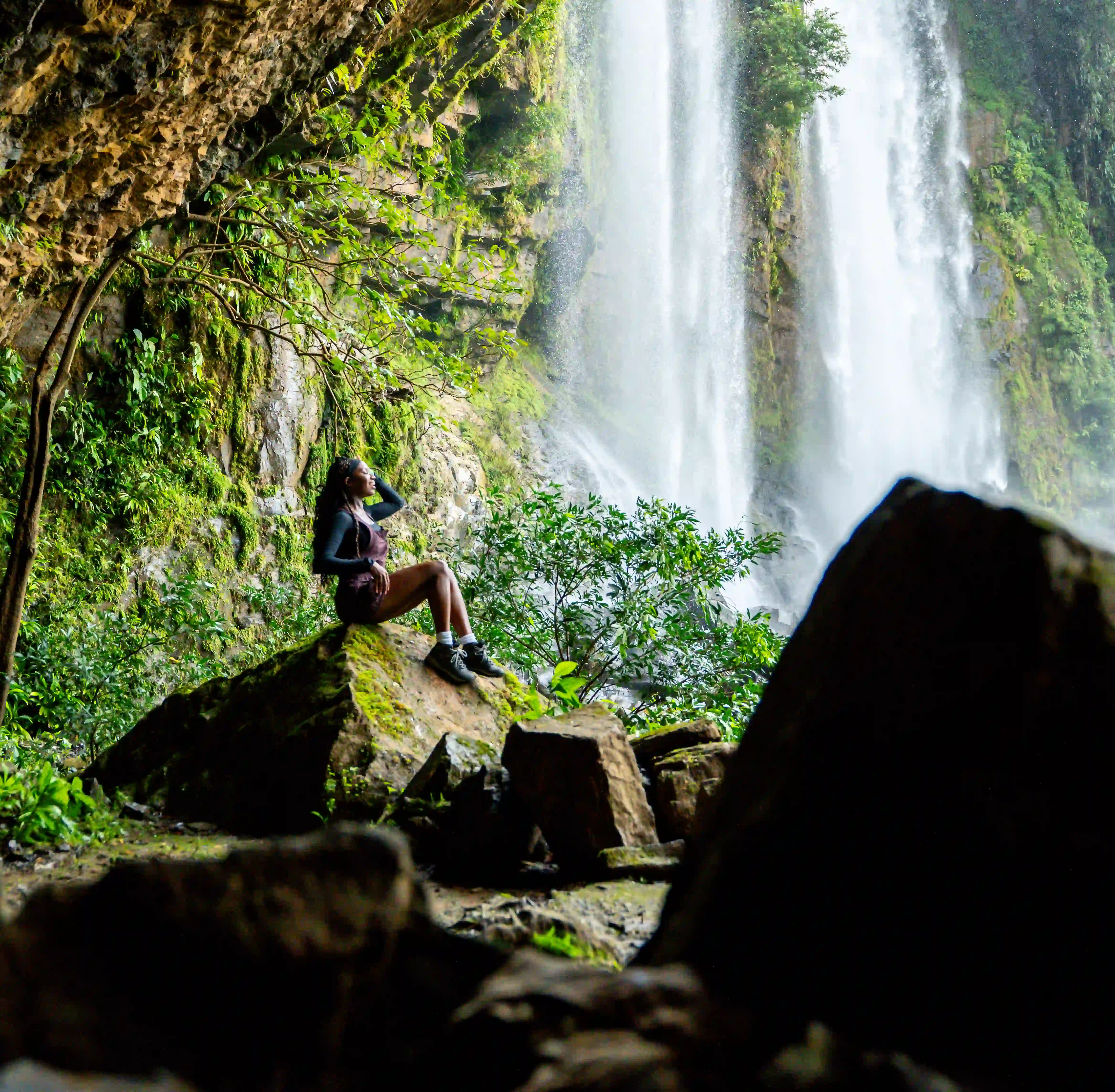 Guest exploring a waterfall near Vajra Jahra Retreat Center in Costa Rica.