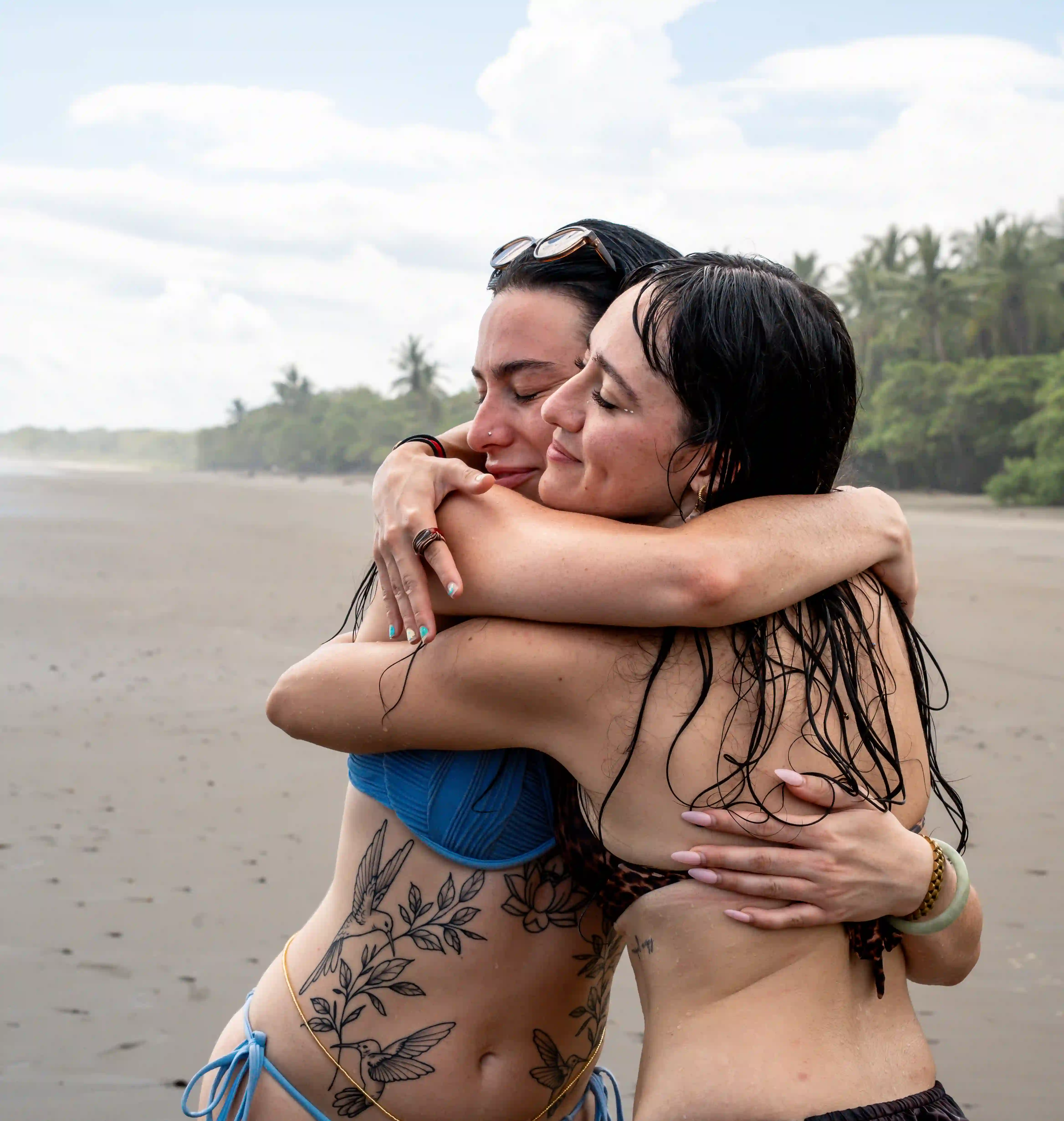 Guests hugging on the beach during their stay at Vajra Jahra Wellness Retreat Center in Costa Rica.