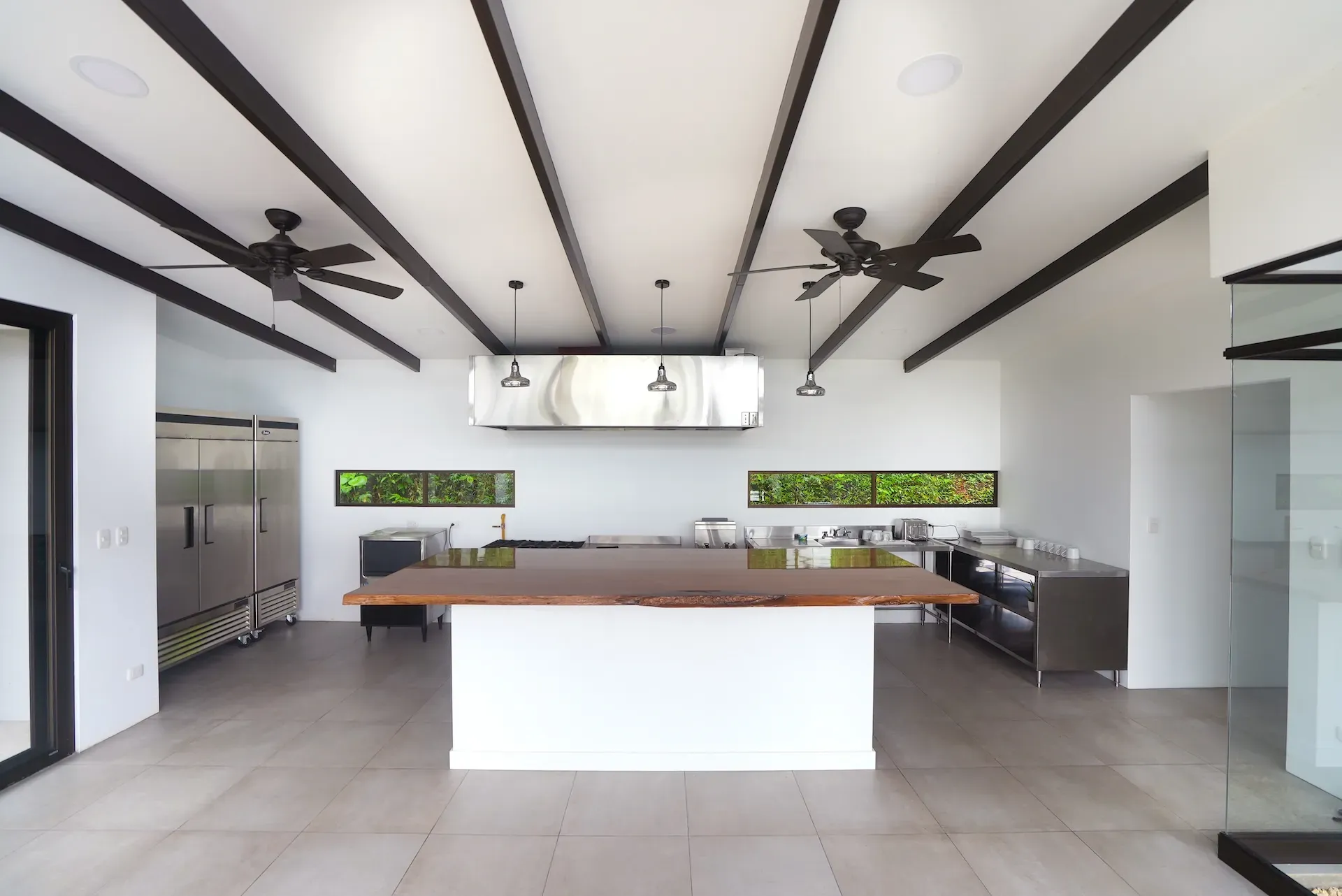 Modern chef’s kitchen at Vajra Jahra retreat center in Costa Rica, designed for group dining and wellness retreats.
