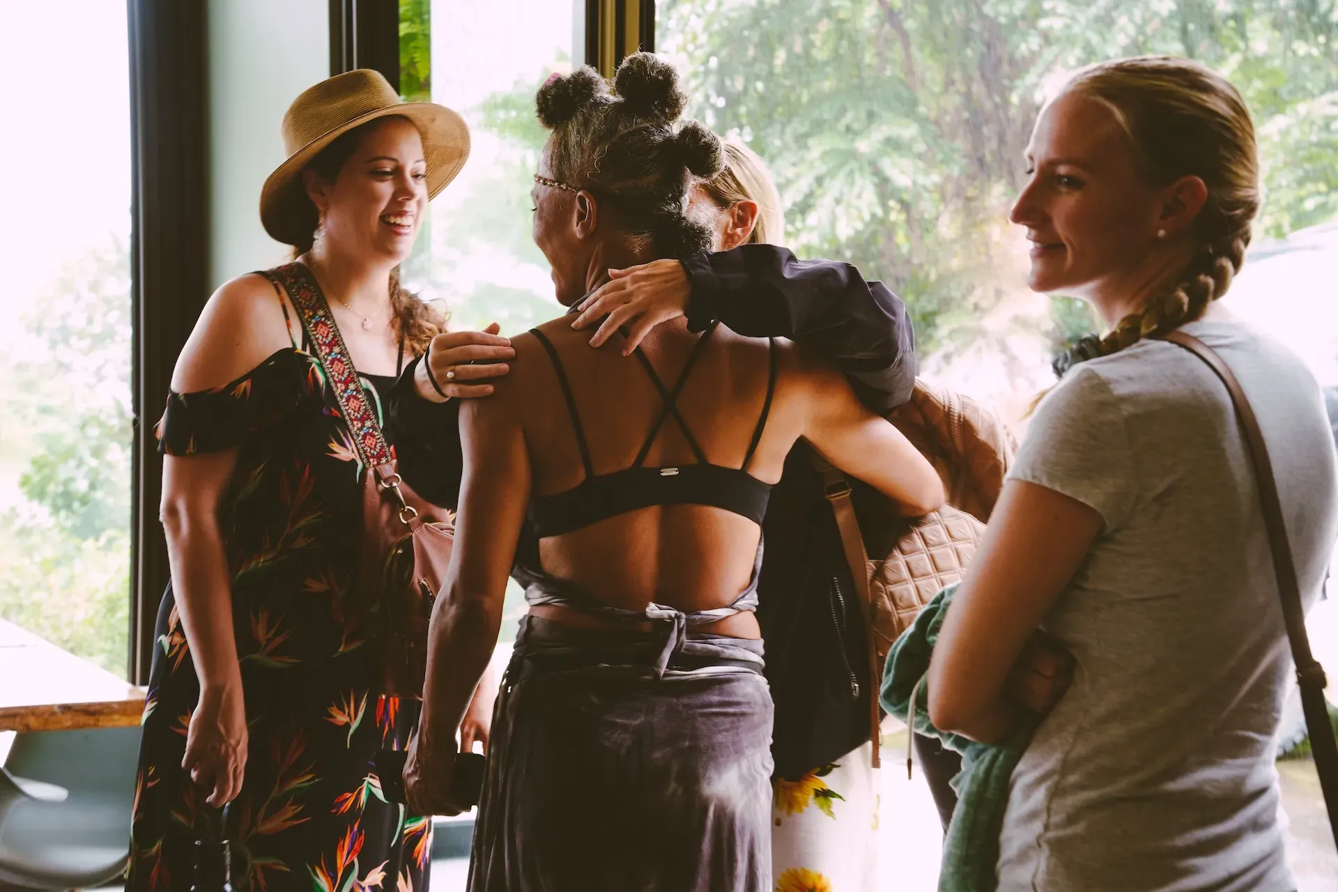 Four guests conversing at Vajra Jahra retreat center, surrounded by the beautiful scenery of Costa Rica's jungle.