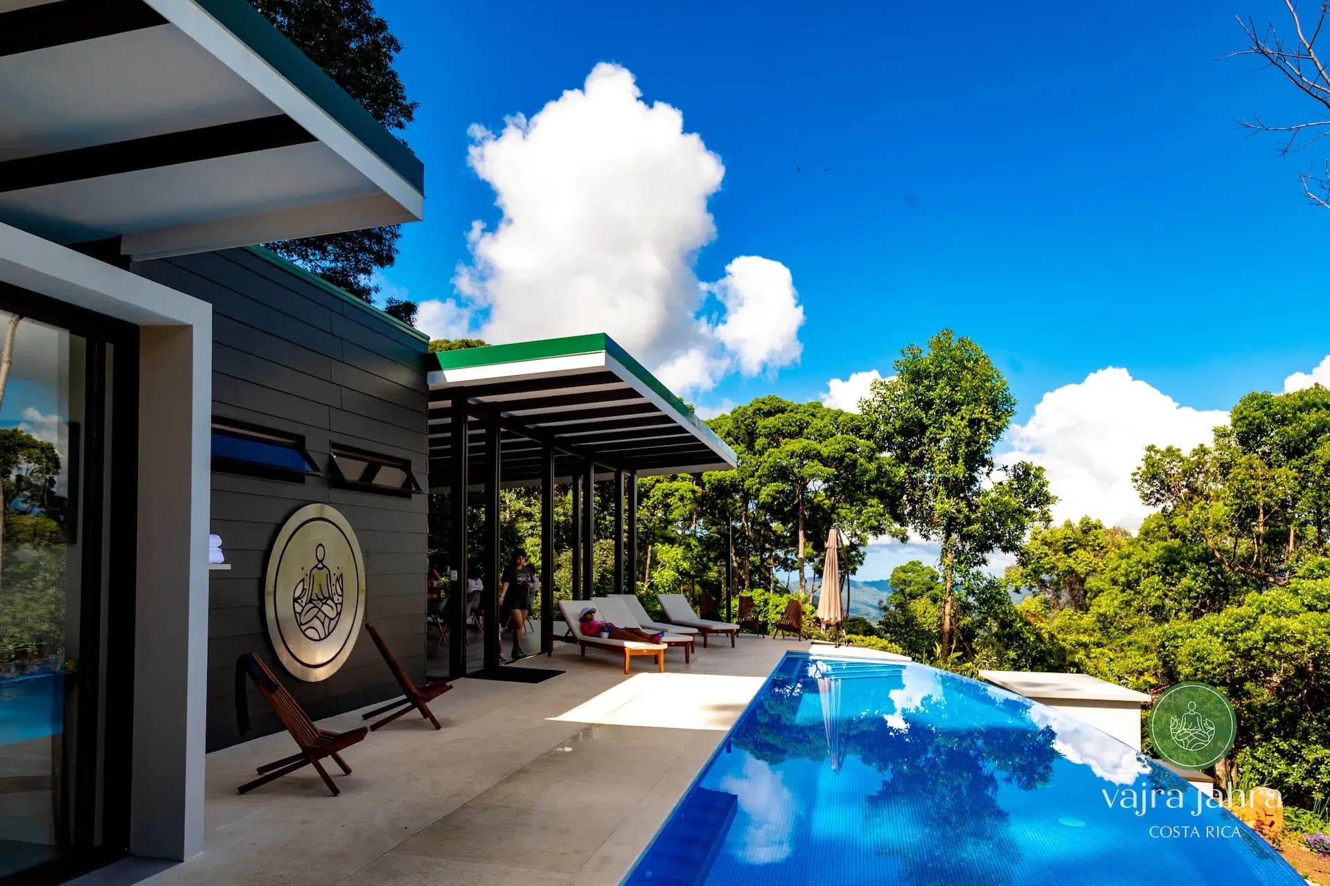 Side view of Vajra Jahra’s main building and infinity pool at a yoga retreat center in Costa Rica’s jungle.