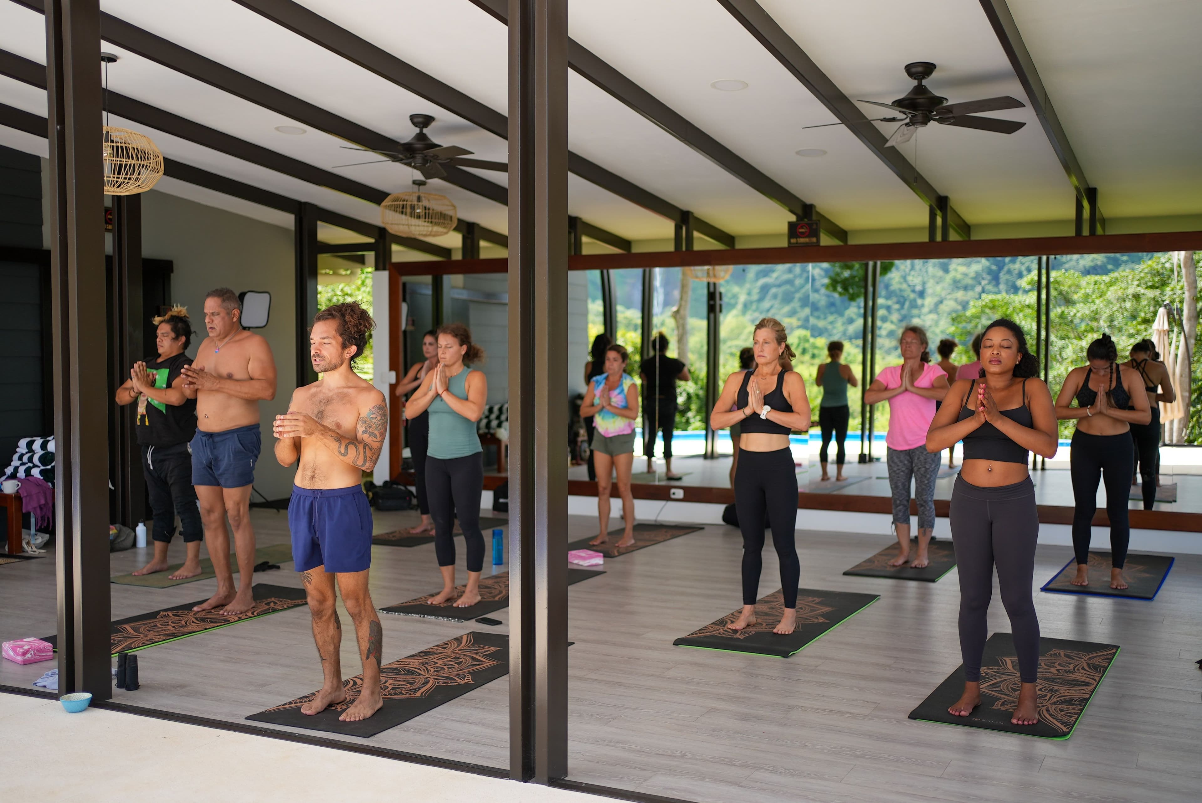 group of people practicing yoga in our studio at Vajra Jahra Retreat Center