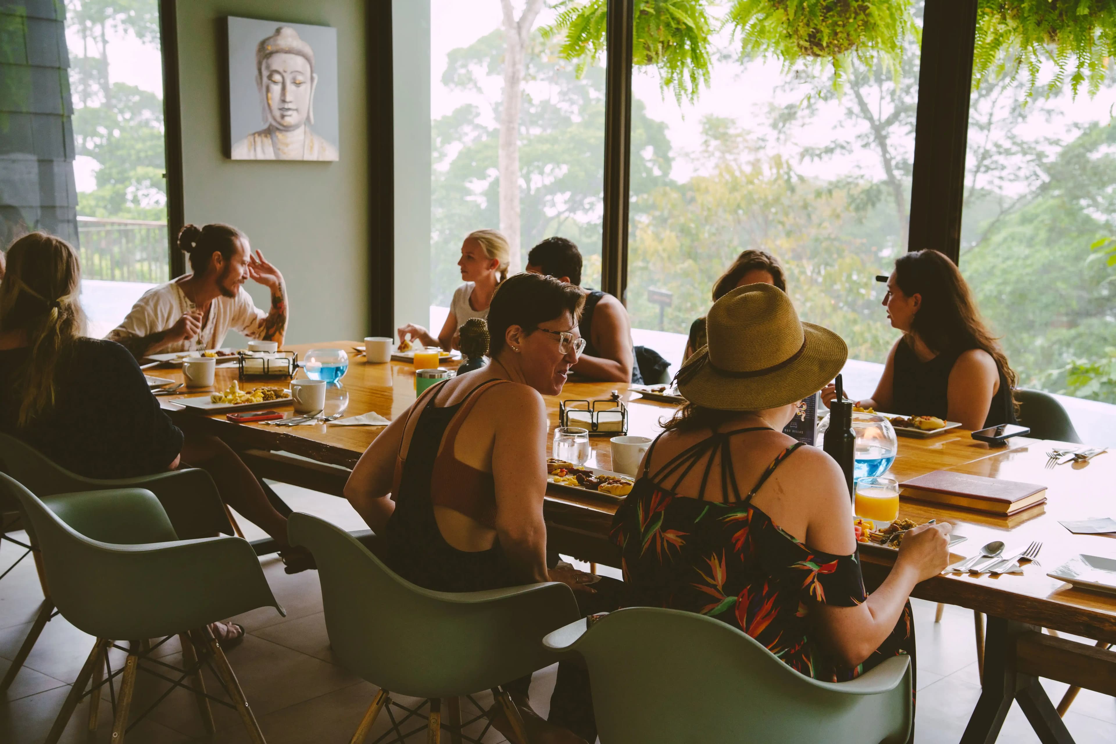 Guests sitting at the table enjoying locally sourced food in al fresco dining area.