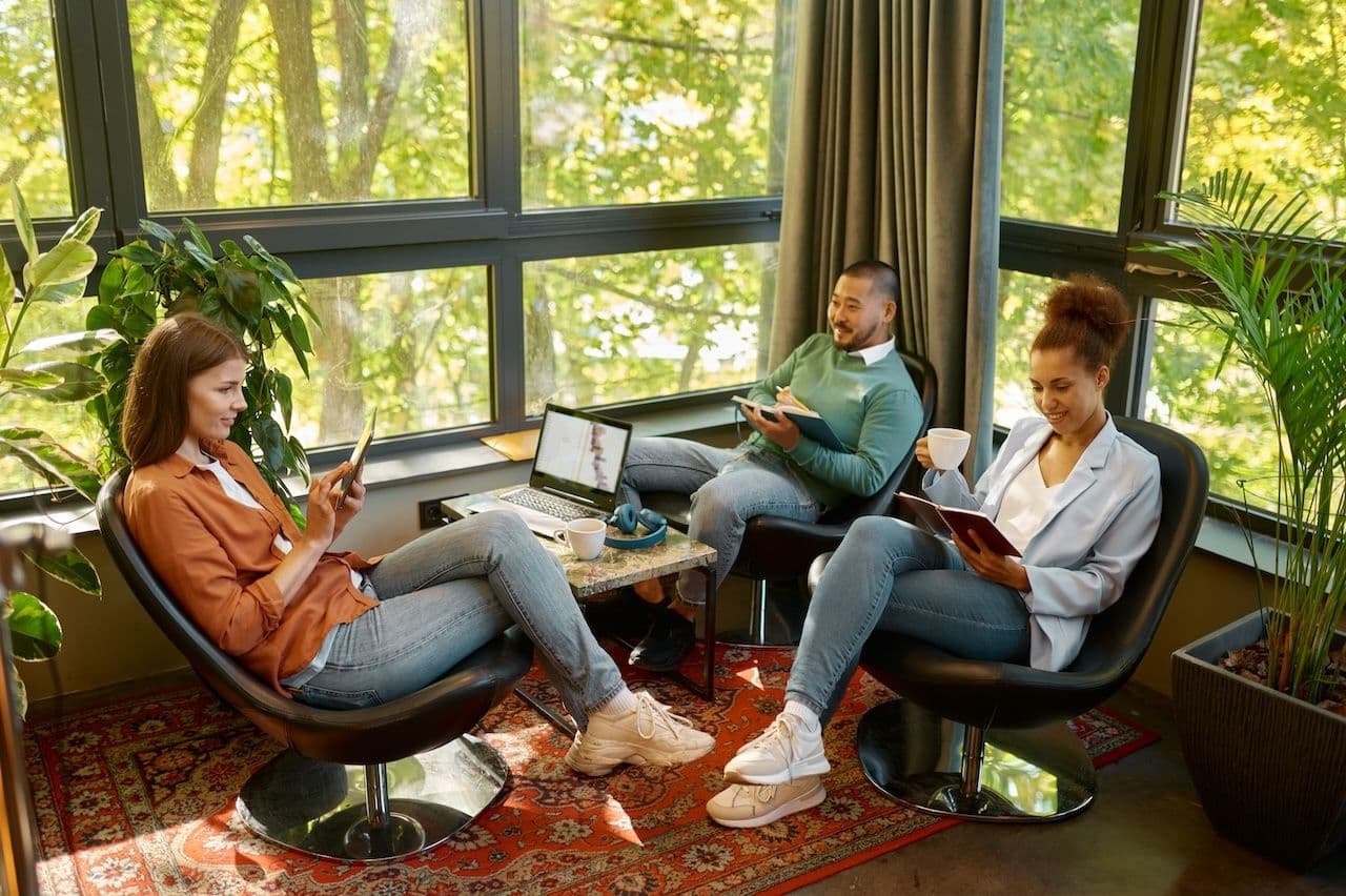 3 people reading and lounging at luxury corporate retreat locations