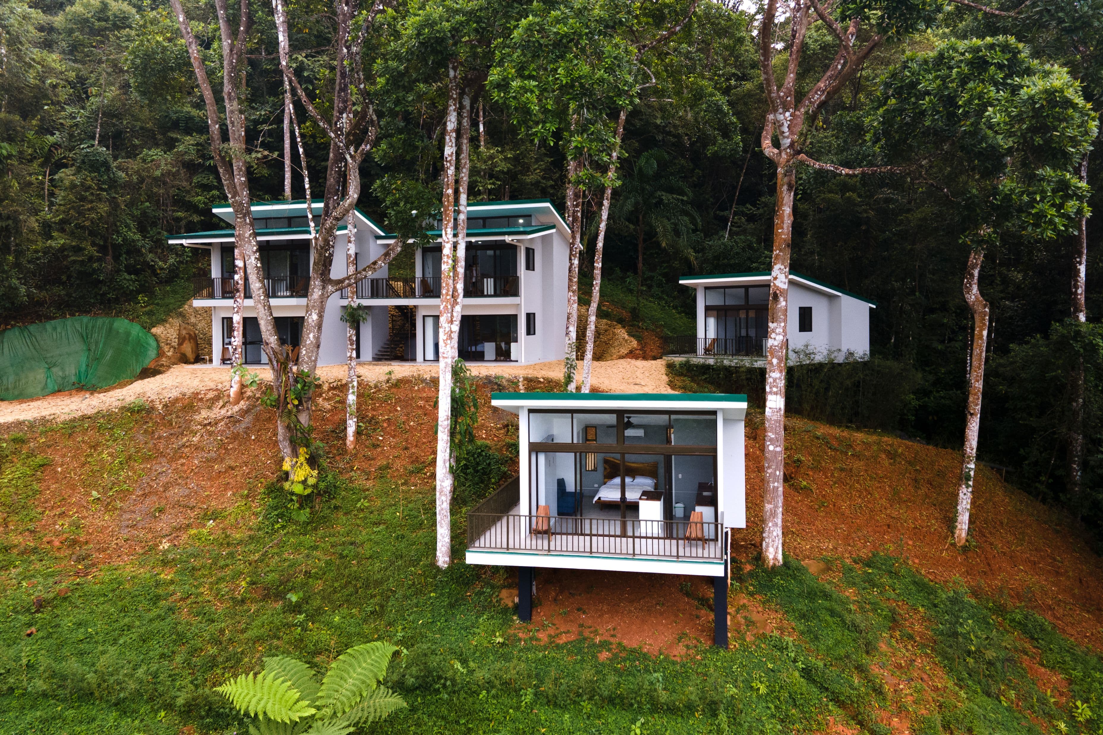 Aerial view of 6 out of 12 private studios at our Costa Rica Retreat Center, nestled in lush jungle surroundings and fully immersed in nature.
