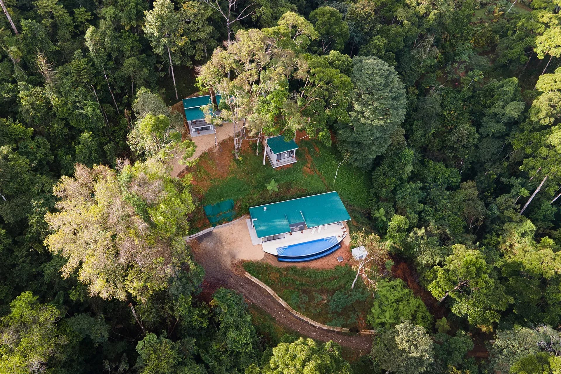 Aerial view of the property showing main building and surrounding villas immersed in nature.