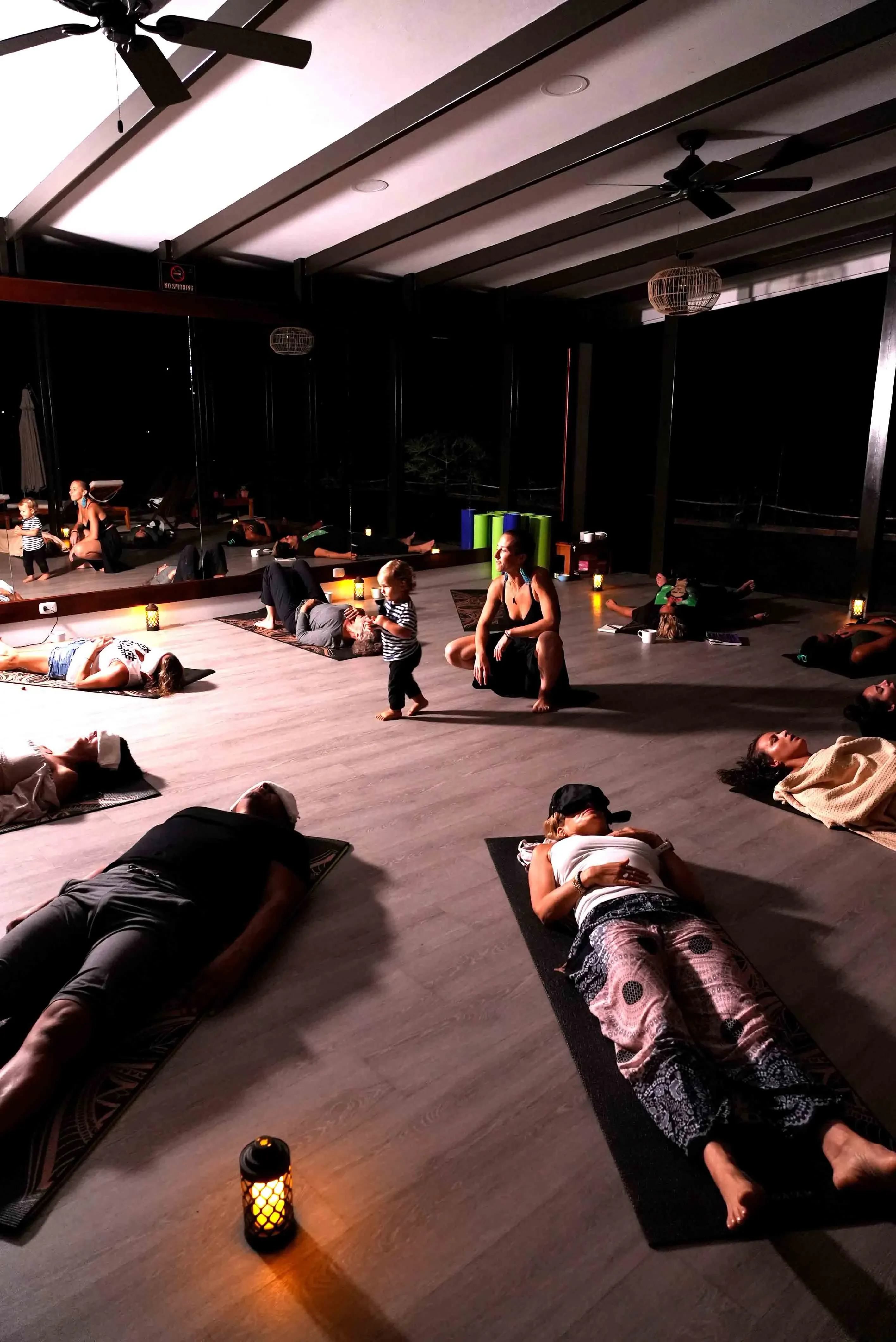 Guests laying down meditating in the open-air shala.