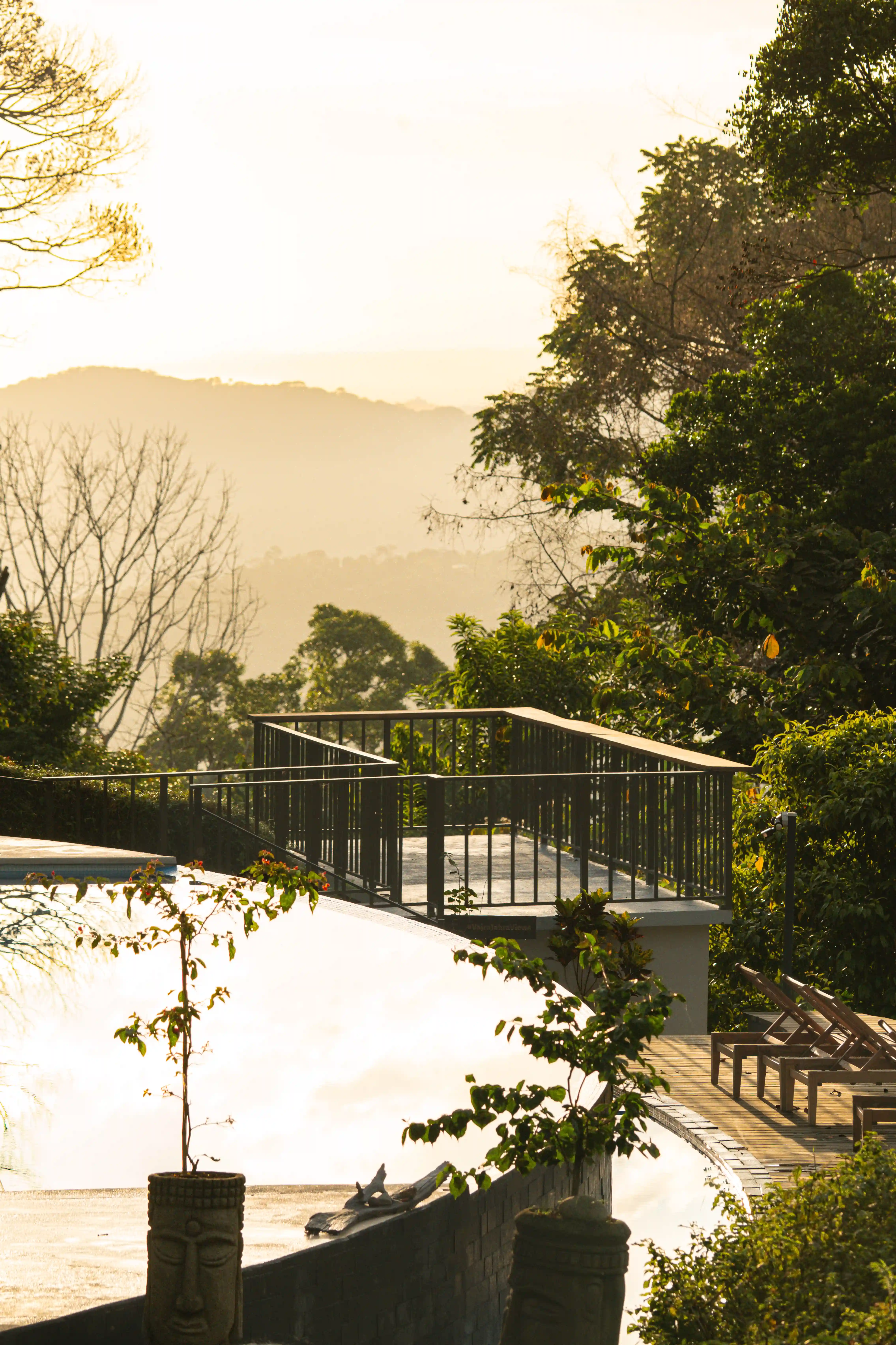 Outdoor viewing deck surrounded by lush greenery at Vajra Jahra Retreat Center, perfect for group gatherings and Family Reunion Vacation Rentals.