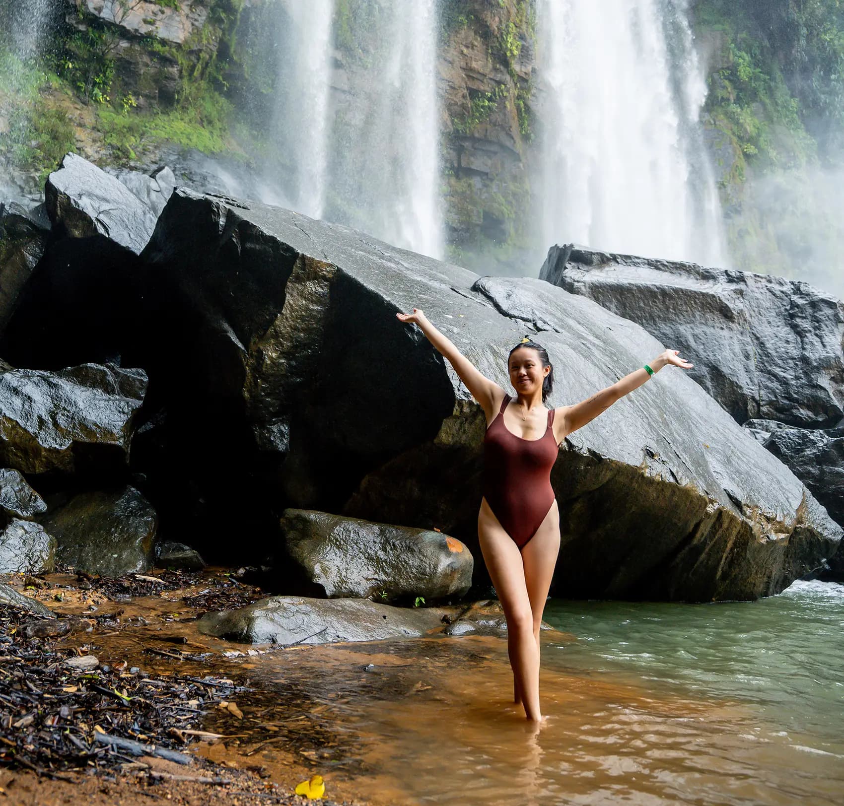 Guest enjoying a refreshing waterfall excursion surrounded by the natural beauty of Costa Rica.