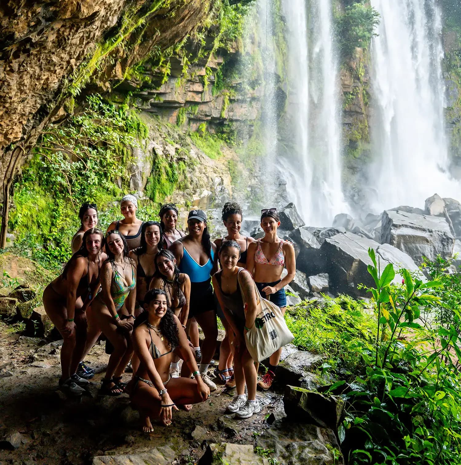 Guests explore the lush jungle beside a powerful cascade at Nauyaca Waterfall Costa Rica, embodying the adventurous spirit guests experience at Vajra Jahra.