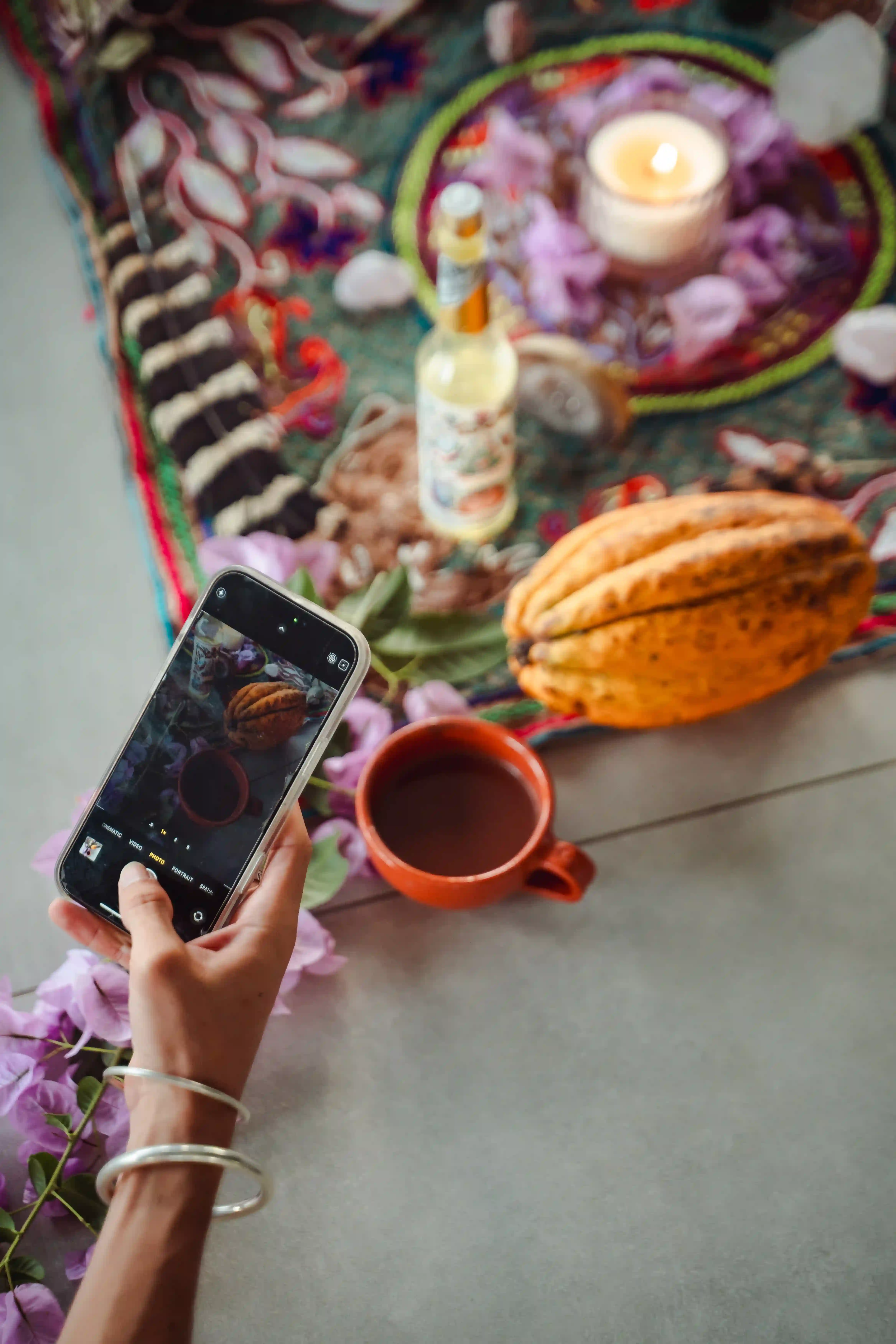Ceremonial cacao surrounded by colorful flowers at Vajra Jahra, reflecting the grounding rituals of the Wellness Retreat Center.