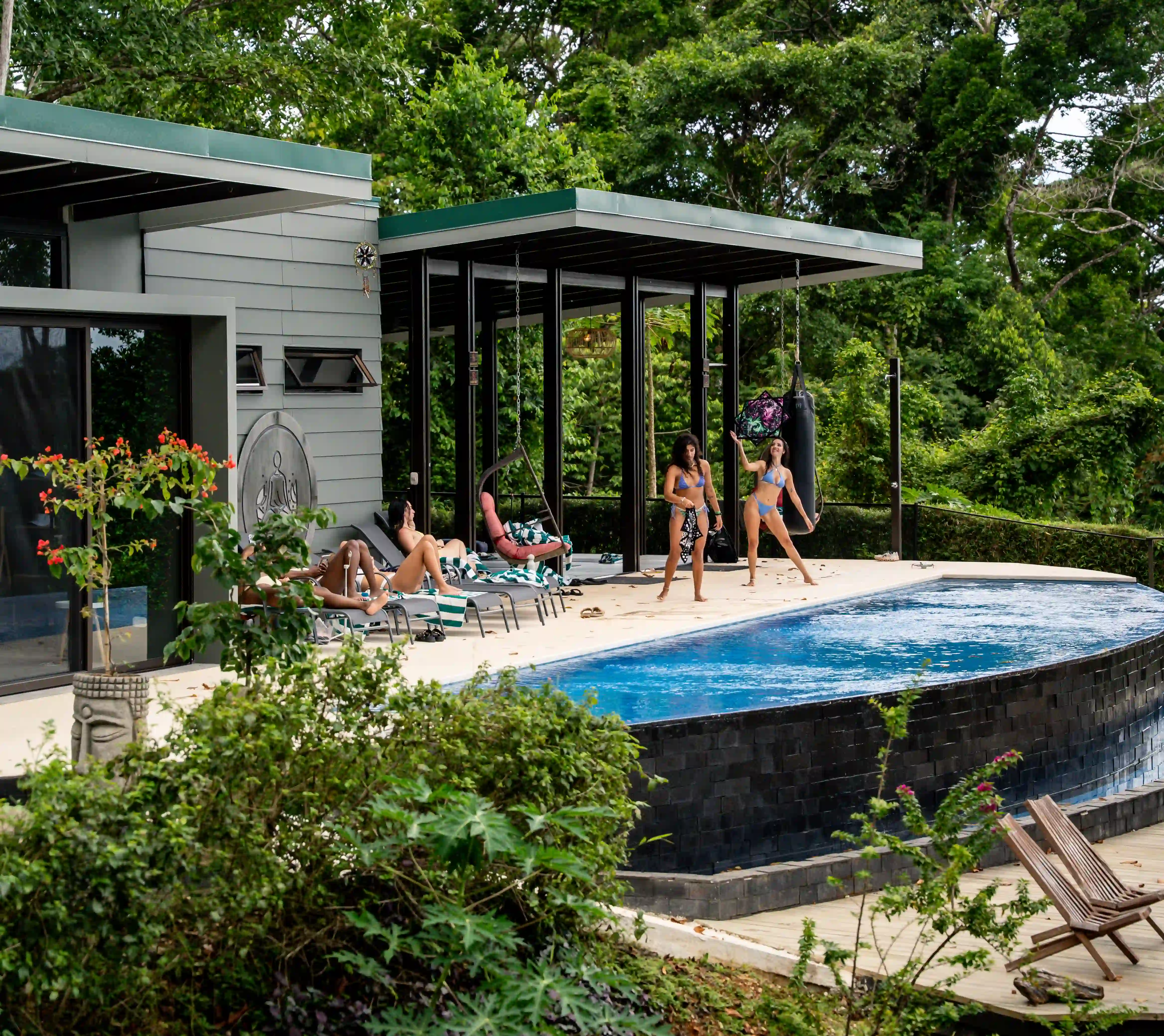 Side view of Vajra Jahra’s main building and infinity pool at a yoga in Costa Rica retreat center jungle.