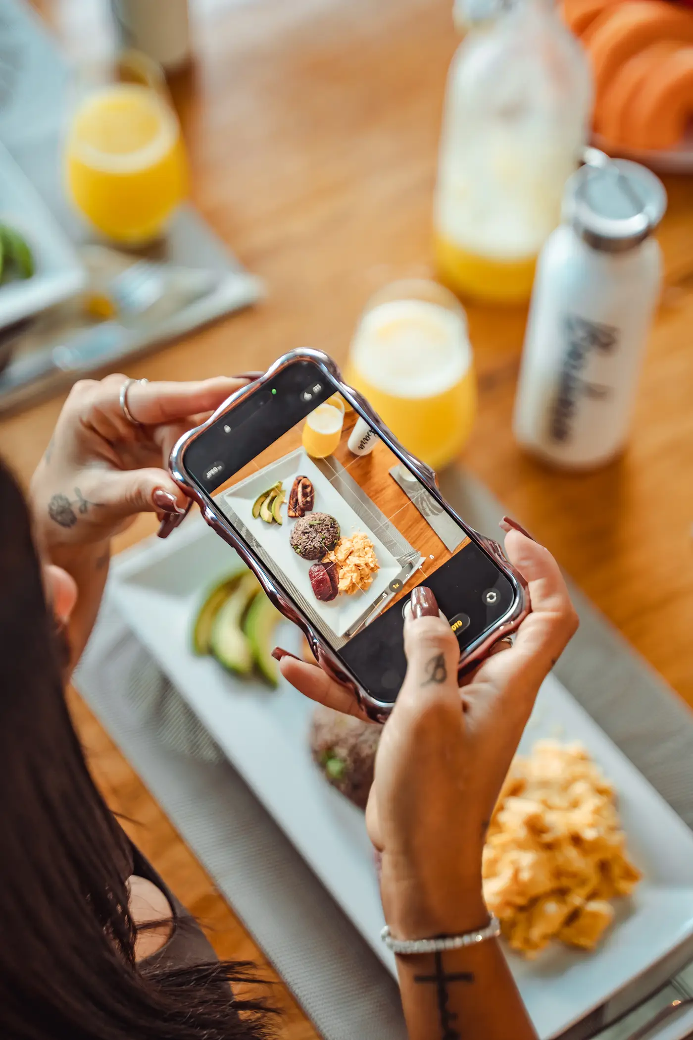 Guest capturing a photo of a nourishing breakfast at Vajra Jahra Wellness Retreat Center.