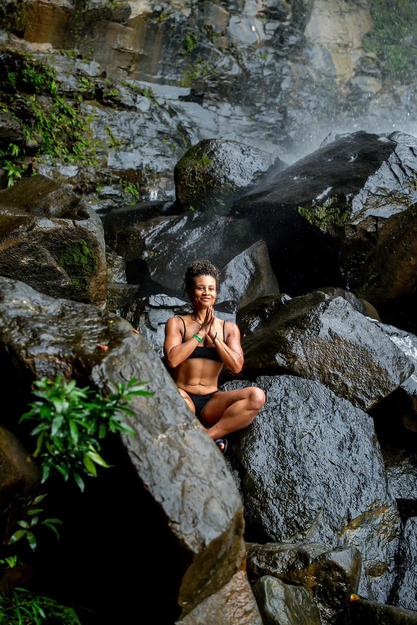 Guest meditating among the rocks in a peaceful natural setting.