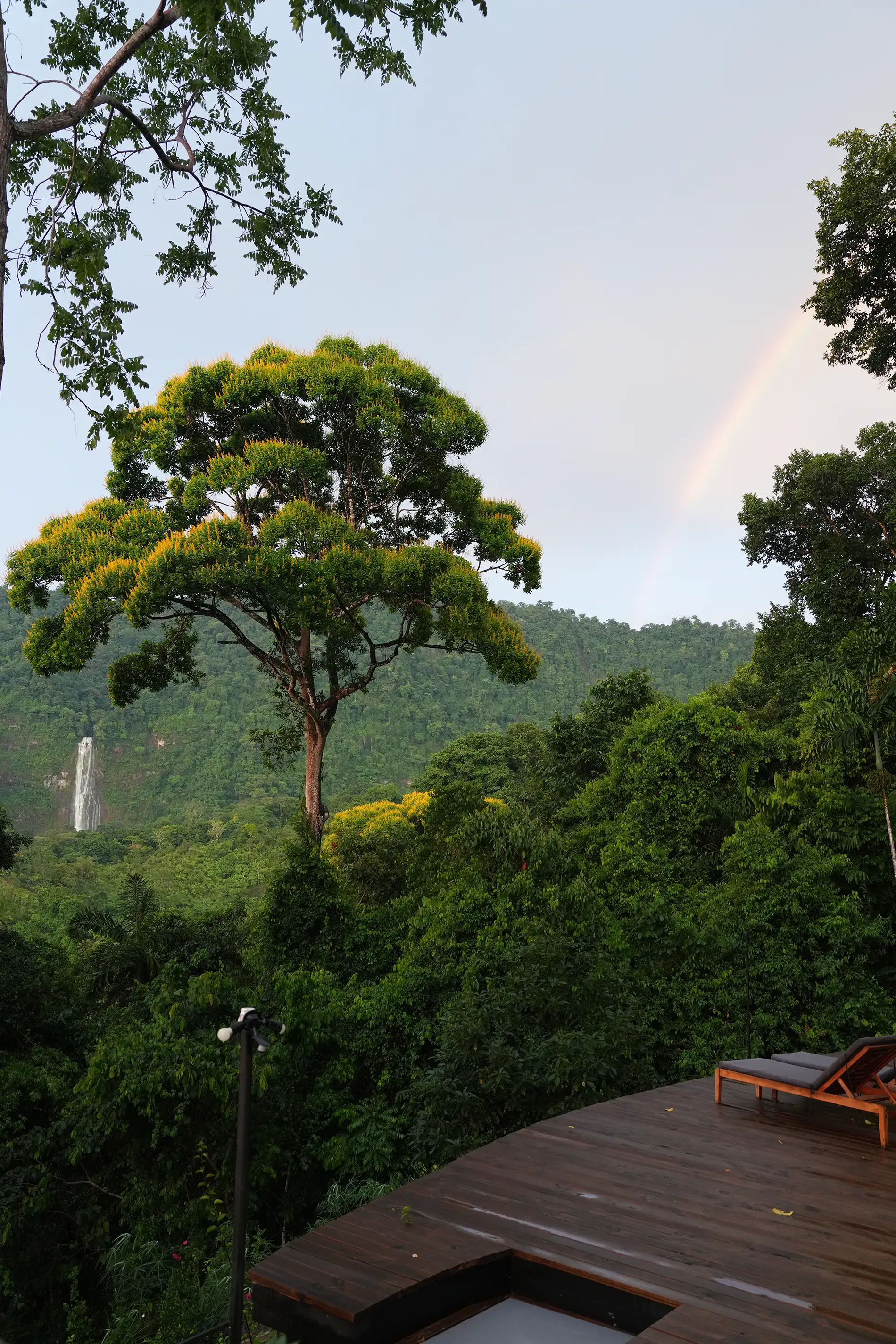 Sky over lush mountains and a distant waterfall near Vajra Jahra, a serene Costa Rica Retreat Center immersed in jungle beauty.
