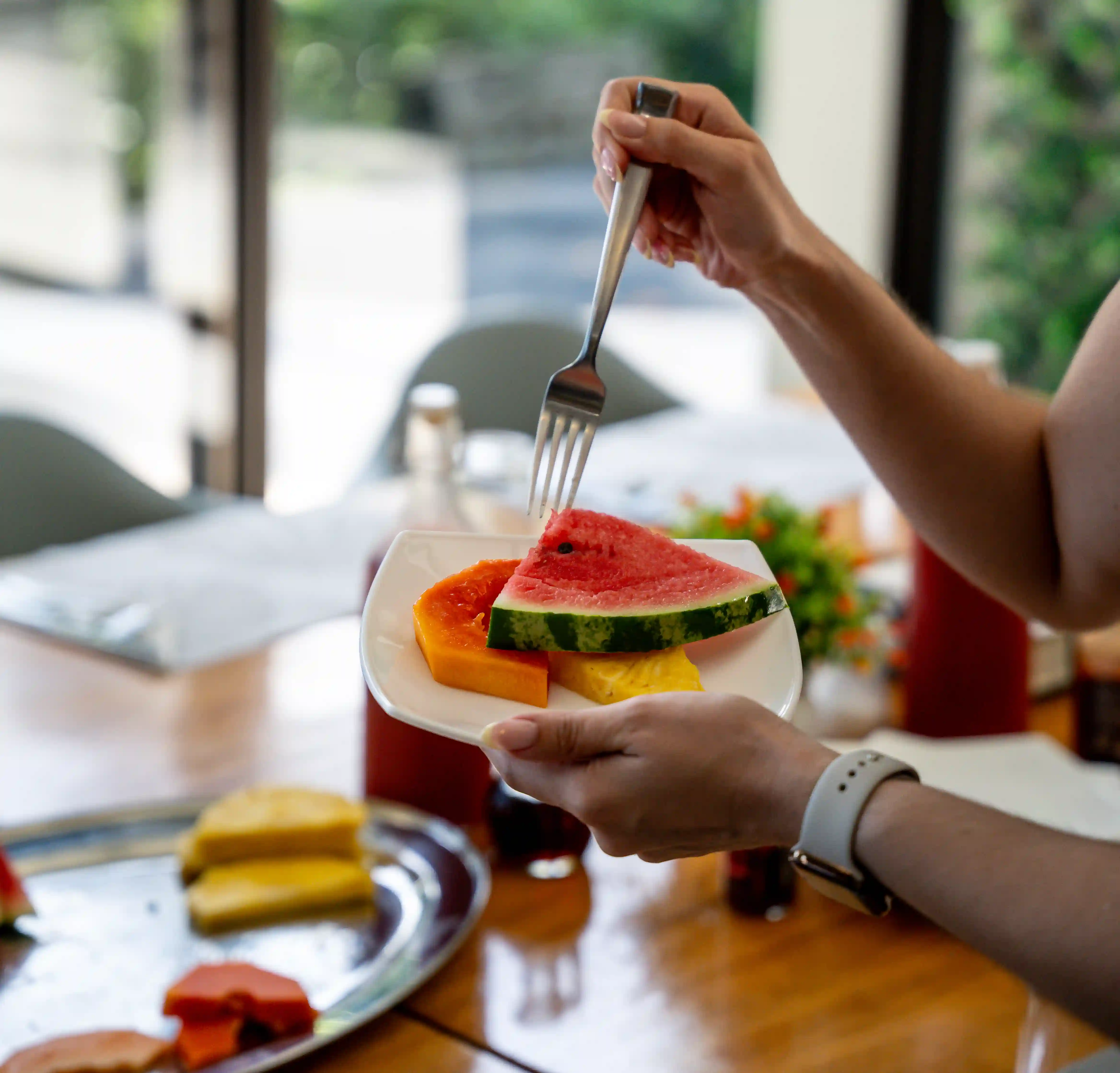 Guest enjoying a watermelonl at Vajra Jahra Retreat Center, showcasing the warm, communal atmosphere of a top Costa Rica wedding venue.