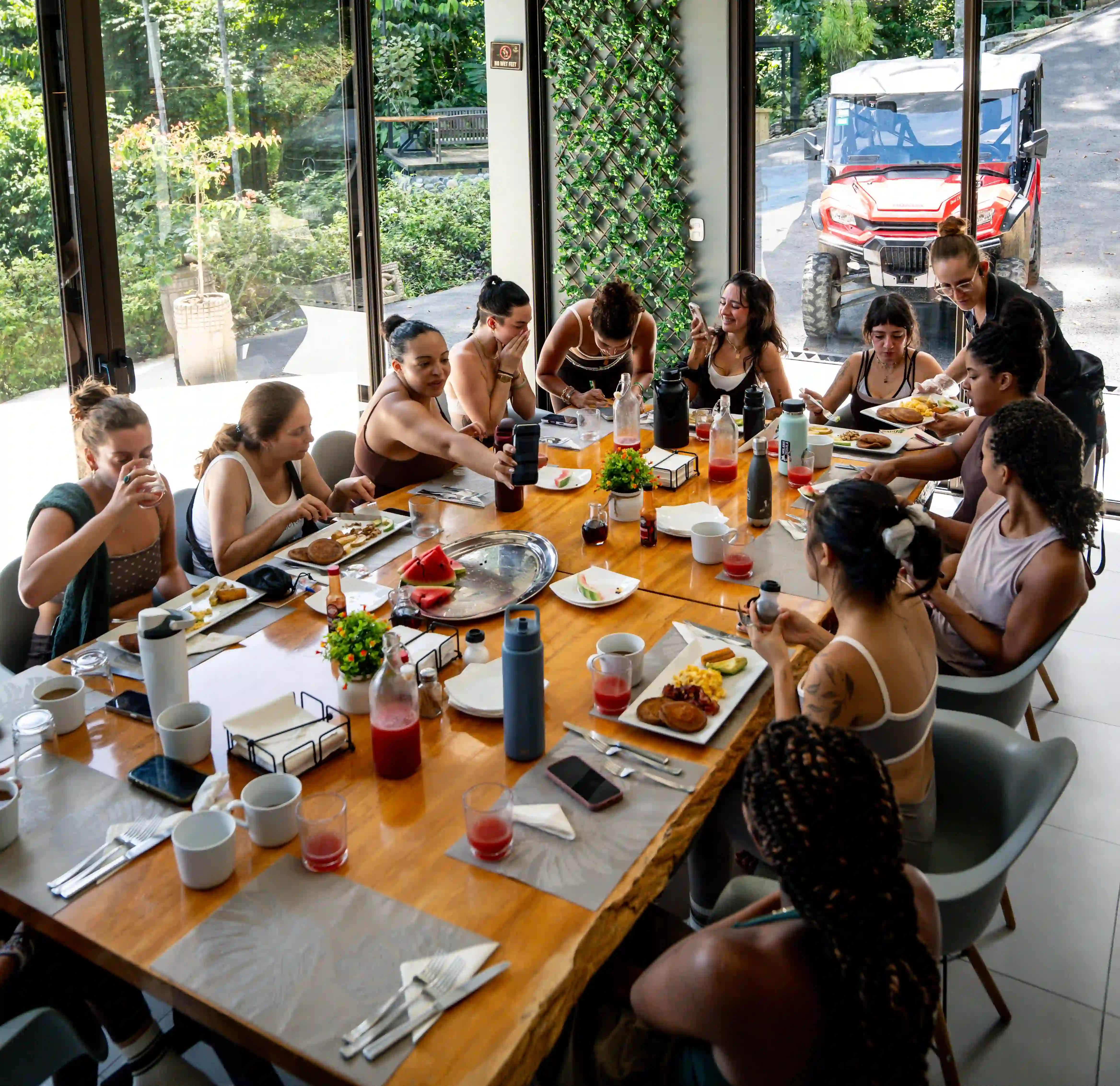 Guests gathering around a vibrant lunch spread at Vajra Jahra Retreat Center, highlighting the wholesome food experiences of a Yoga Retreat in Costa Rica.