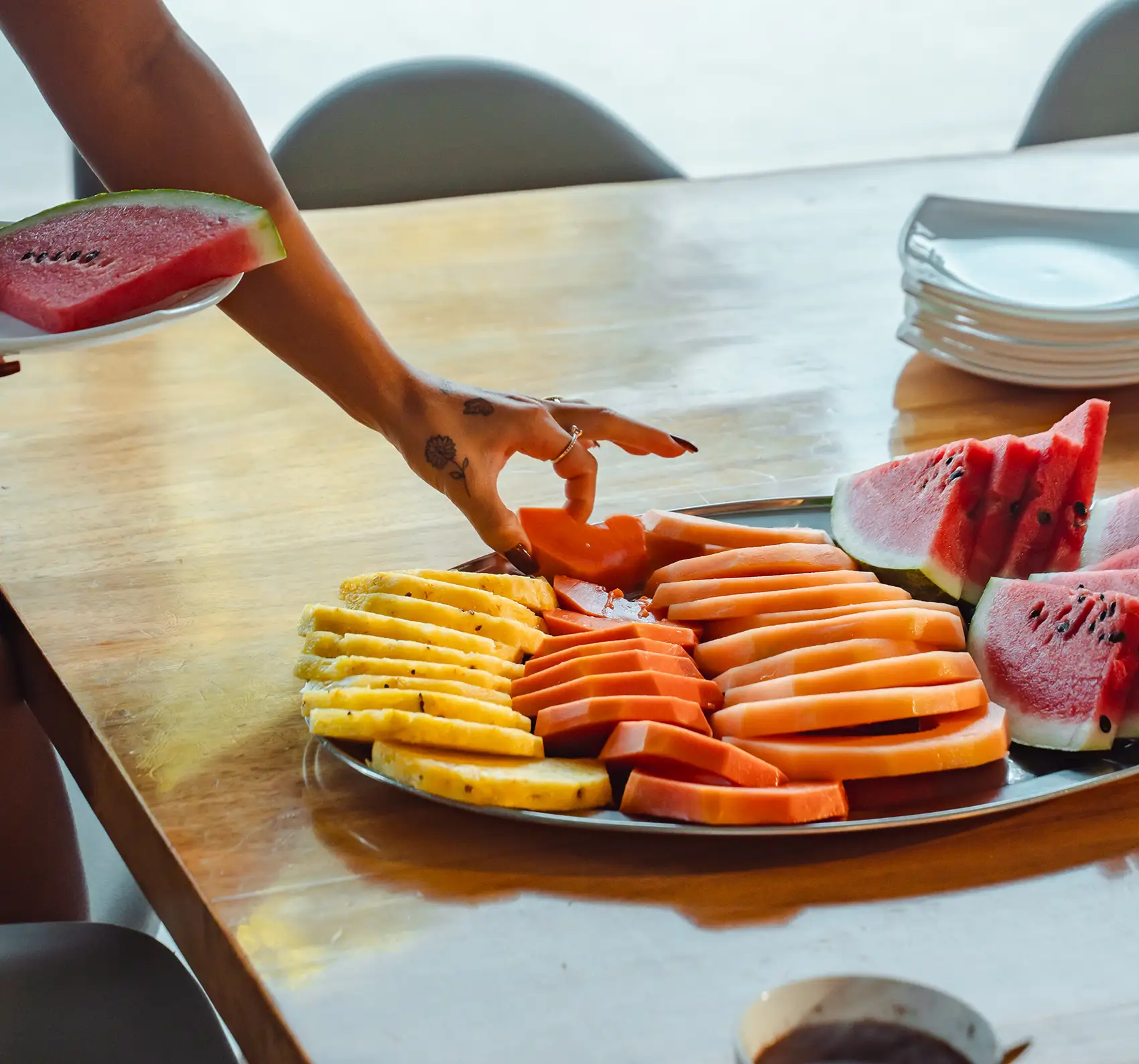 Guest grabbing a fresh, locally inspired fruit at Vajra Jahra Retreat Center, a Corporate Retreat Venue offering chef-prepared dining experiences.