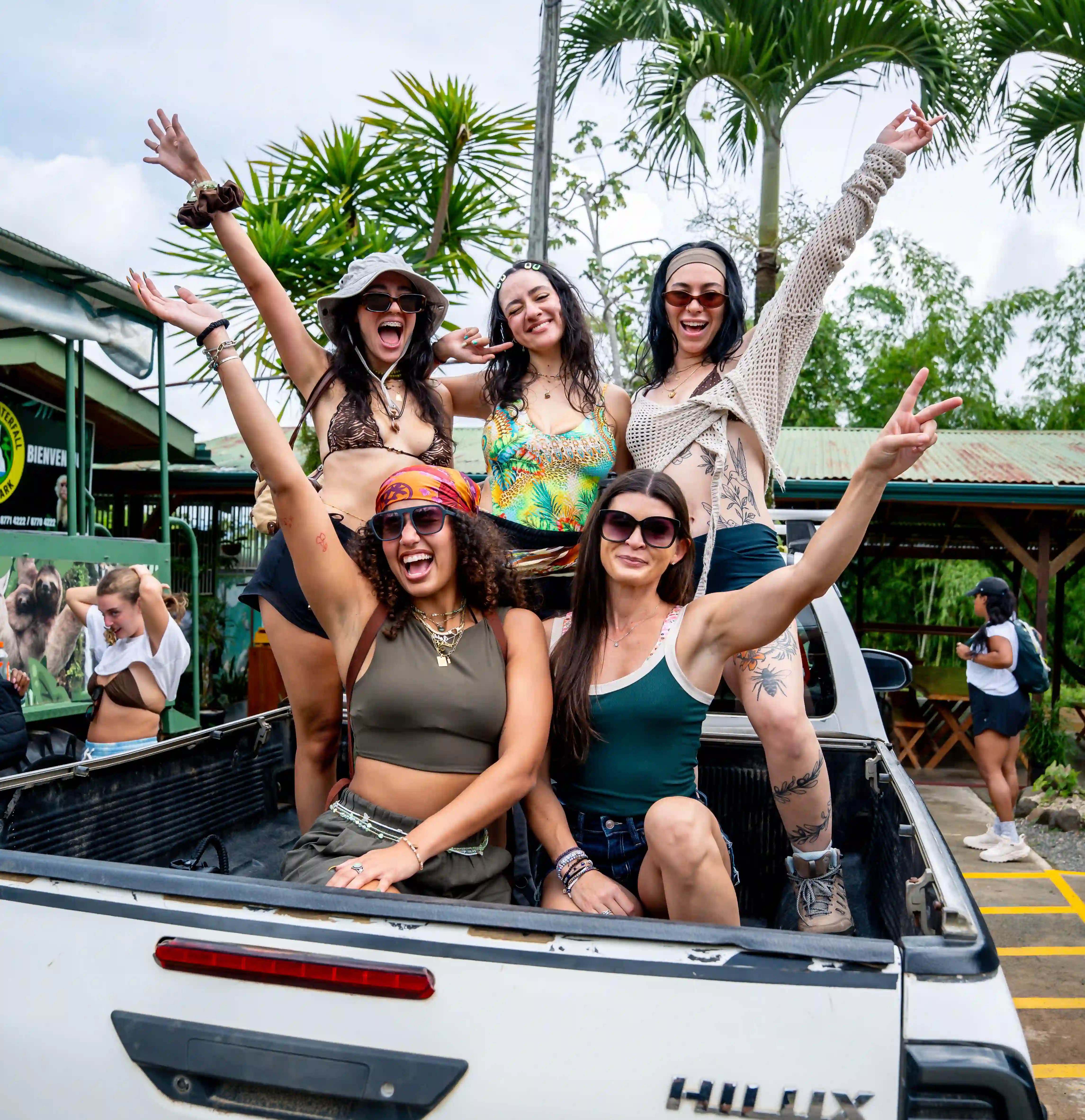Guests sitting in a pickup truck, embracing the adventure of the Vajra Jahra Wellness Retreat Center experience.