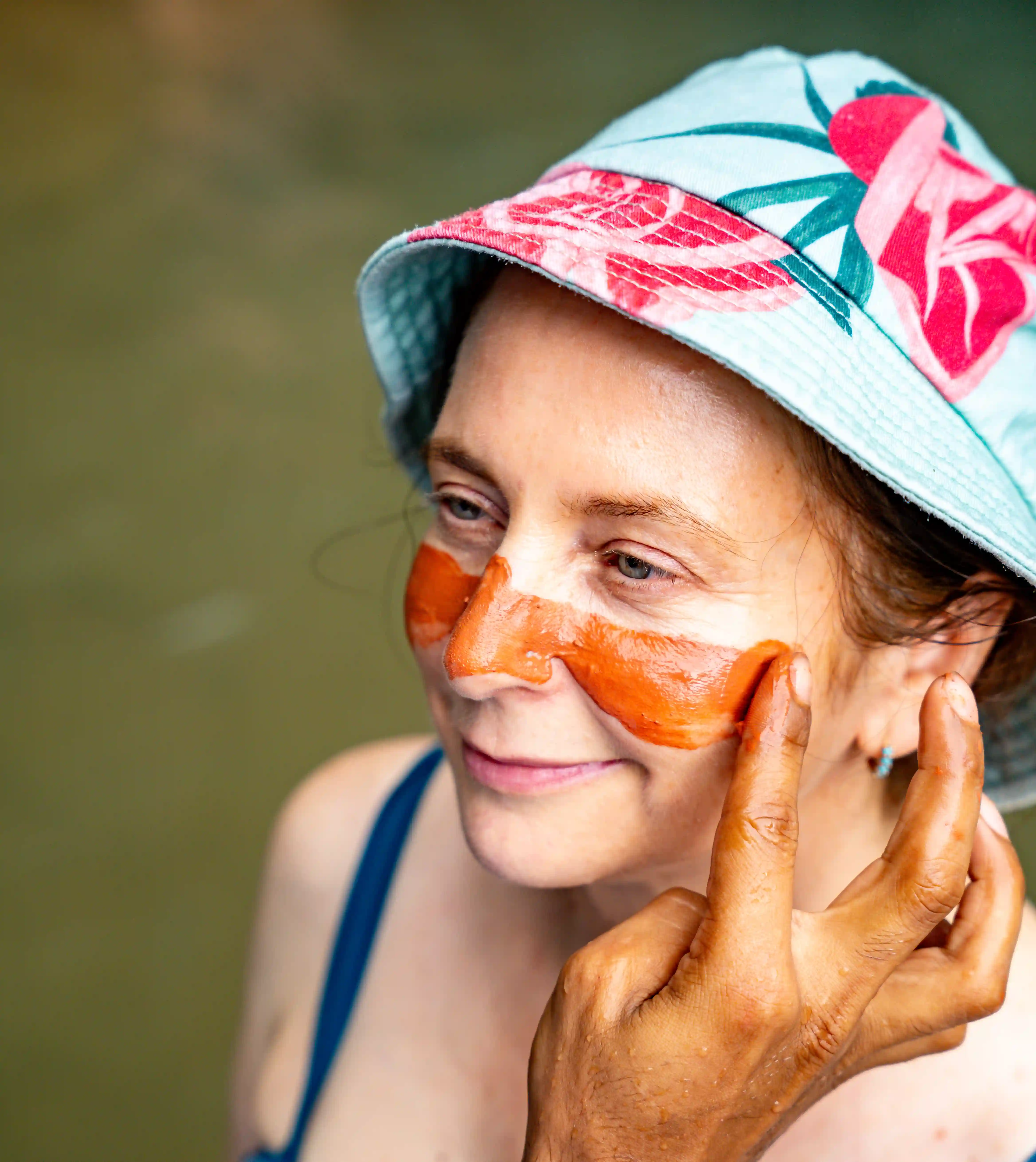 wellness retreat guest receiving mud facial