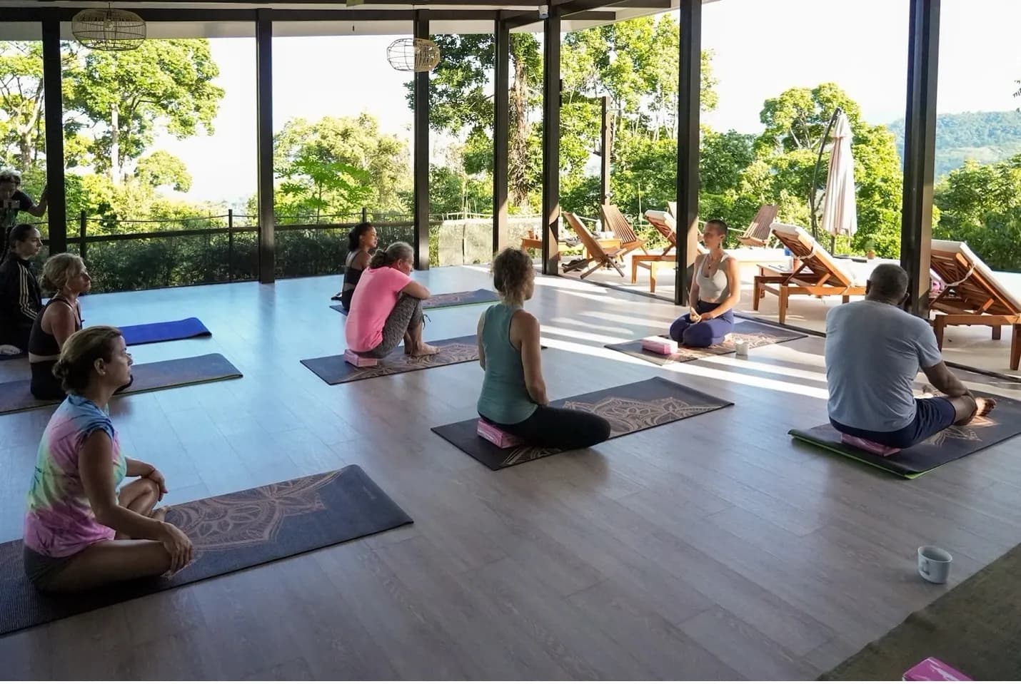 A yoga class in a rainforest yoga shala.