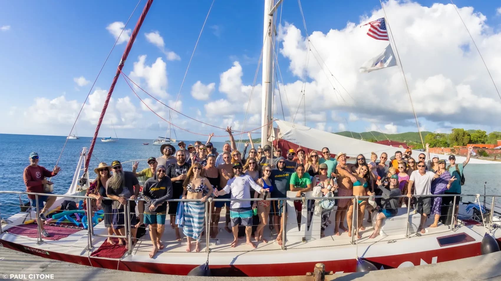 A group enjoying a sunny catamaran excursion with ocean views and vibrant energy at Vajra Jahra Costa Rica Retreat Center.