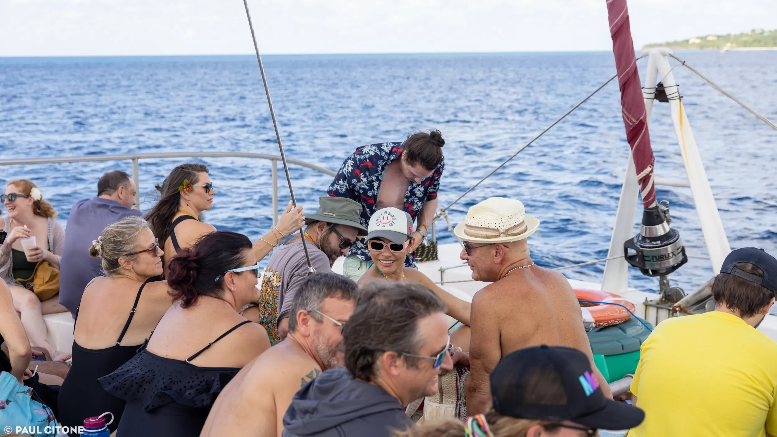 Vajra Jahra Costa Rica Retreat Center guests lounging on a catamaran deck during an ocean excursion with panoramic coastal views.