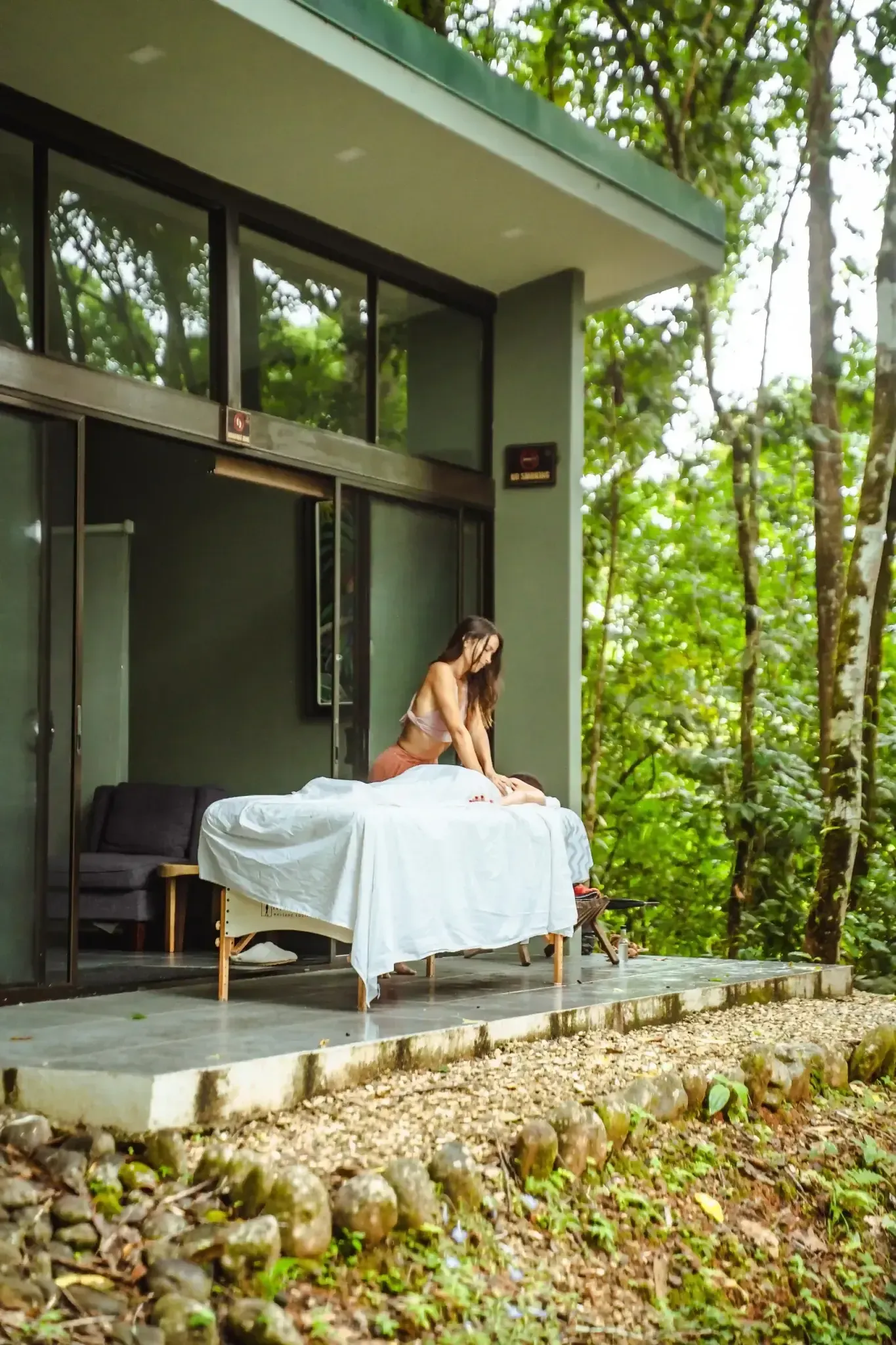 Outdoor massage at Vajra Jahra Retreat Center surrounded by lush jungle.