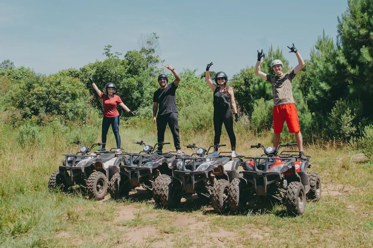 A group of friends celebrating on their ATVs during an outdoor adventure at the Costa Rica Retreat Center, enjoying the lush jungle views near Vajra Jahra.