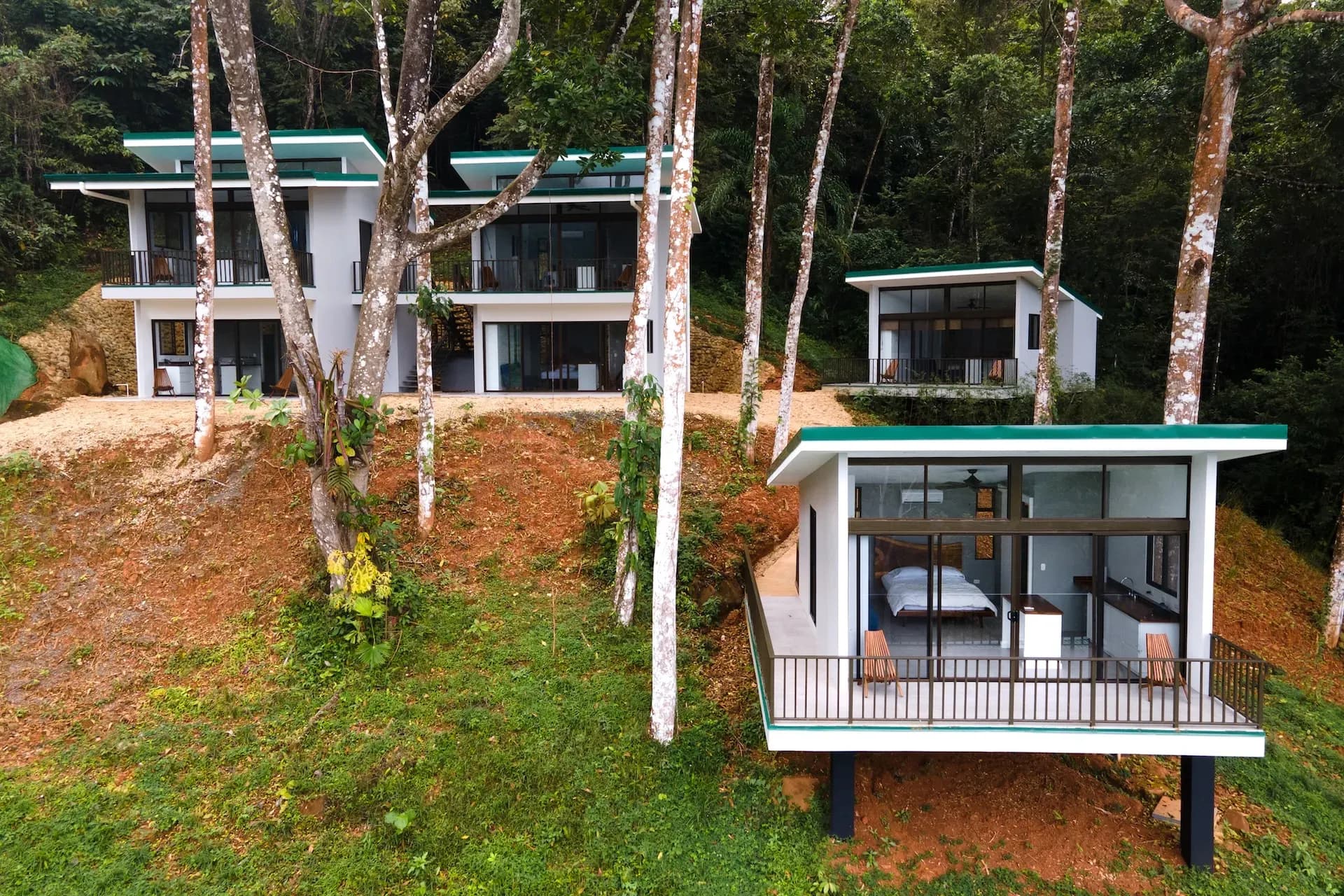 Cluster of modern hillside villas at Vajra Jahra Costa Rica retreat center, surrounded by jungle and nature.