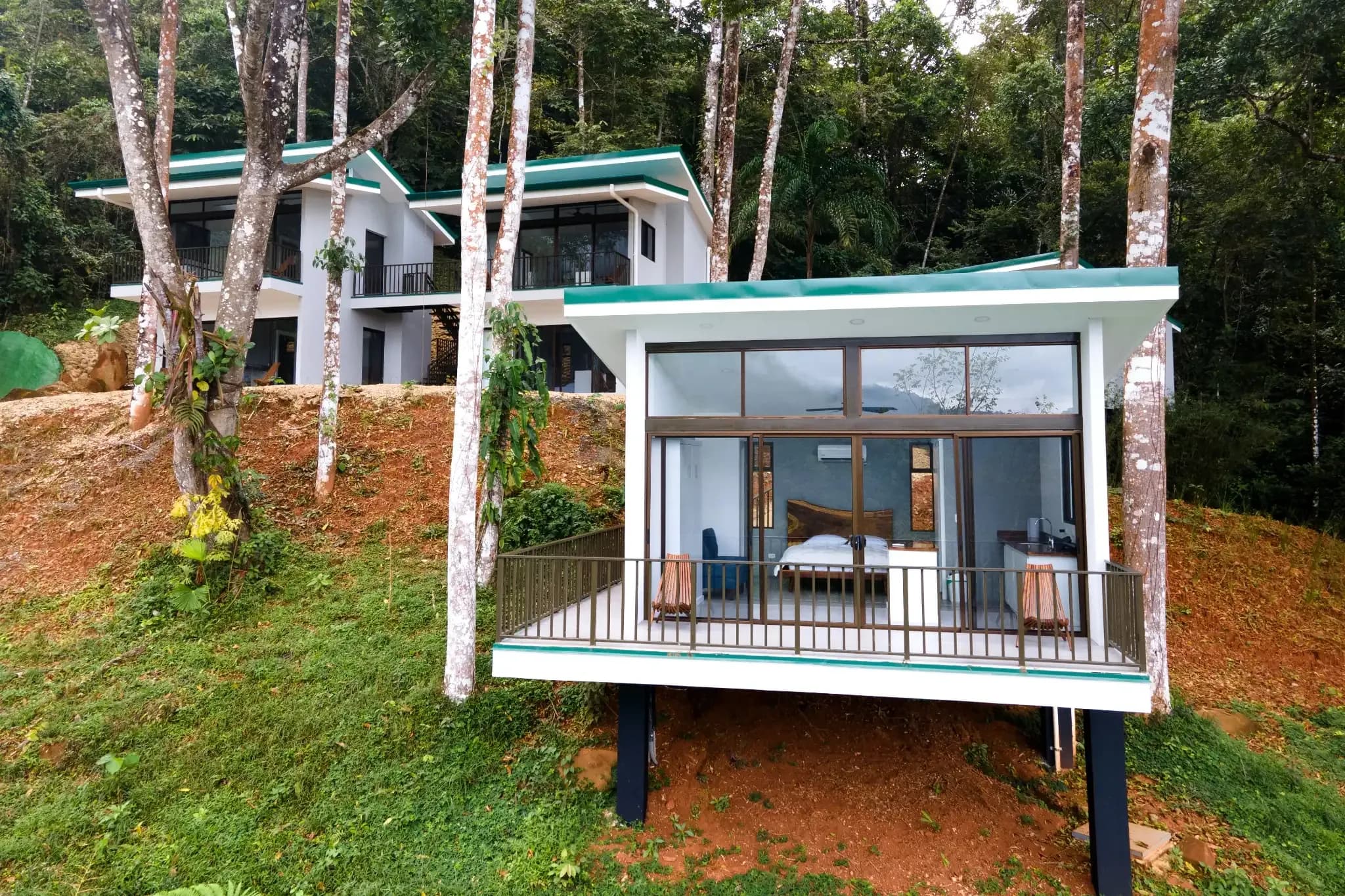 Modern jungle villas at Vajra Jahra Retreat Center surrounded by lush greenery in Costa Rica’s Diamante Valley.