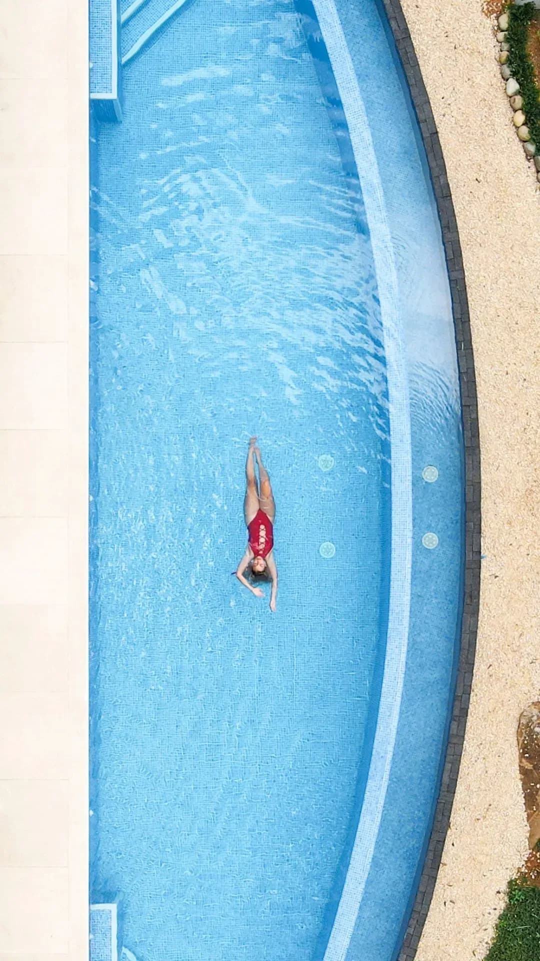 Woman floating peacefully in the infinity pool at Vajra Jahra, a luxury Costa Rica retreat center.
