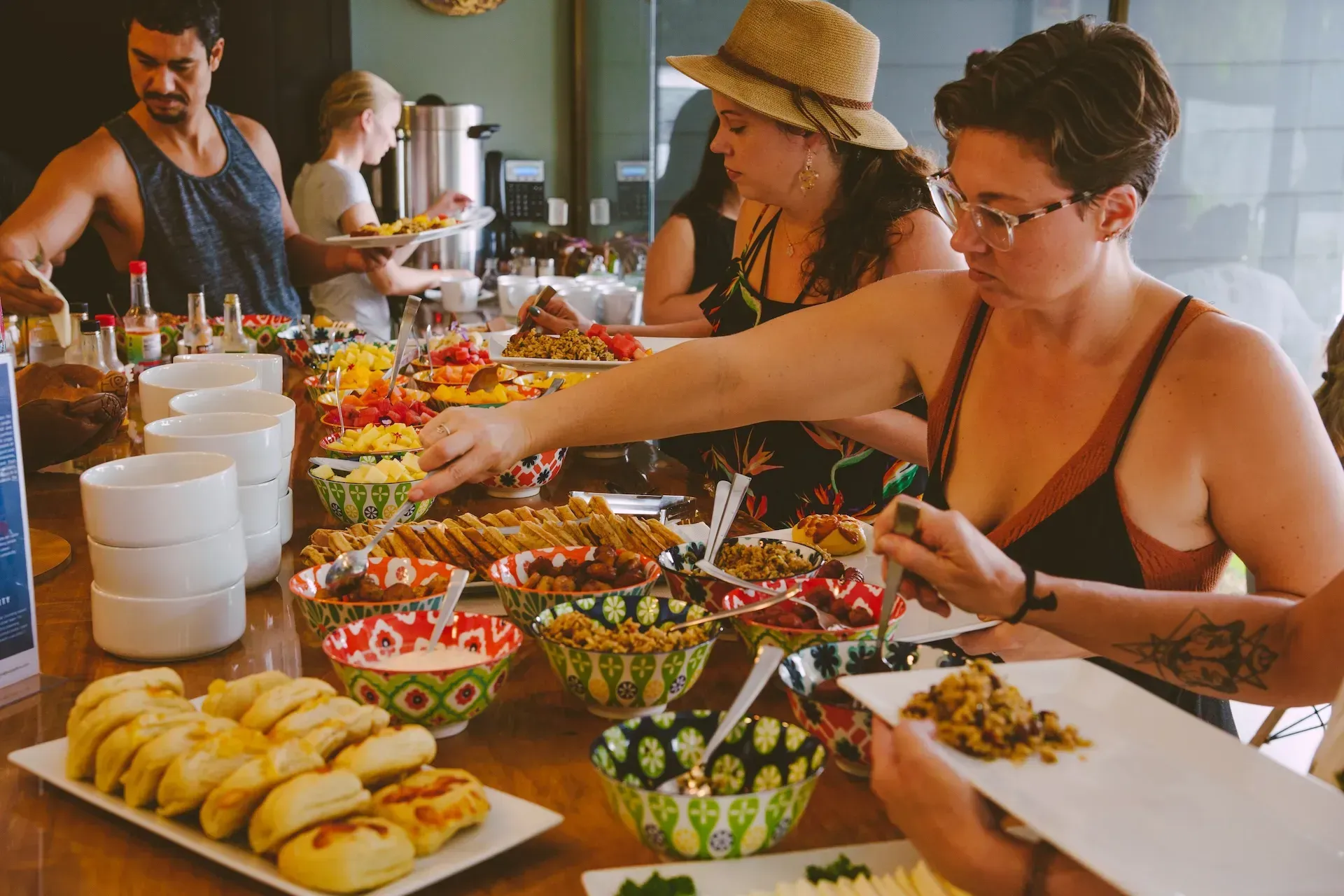 Group dining at a diverse food bar inside the Vajra Jahra Retreat Center, creating a welcoming atmosphere for visitors planning to Rent a Retreat Center.