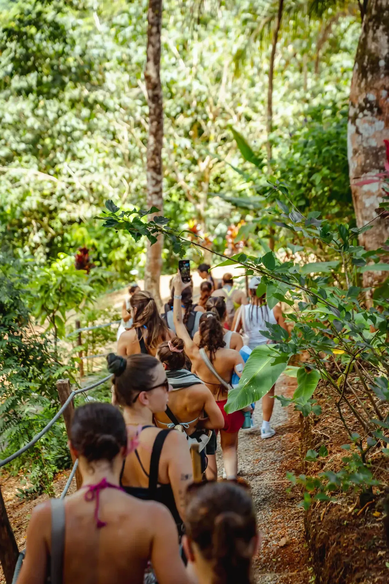 A retreat group hiking together through tropical forest pathways at Vajra Jahra Retreat Center in Costa Rica, a serene setting for leaders looking to rent a retreat center.