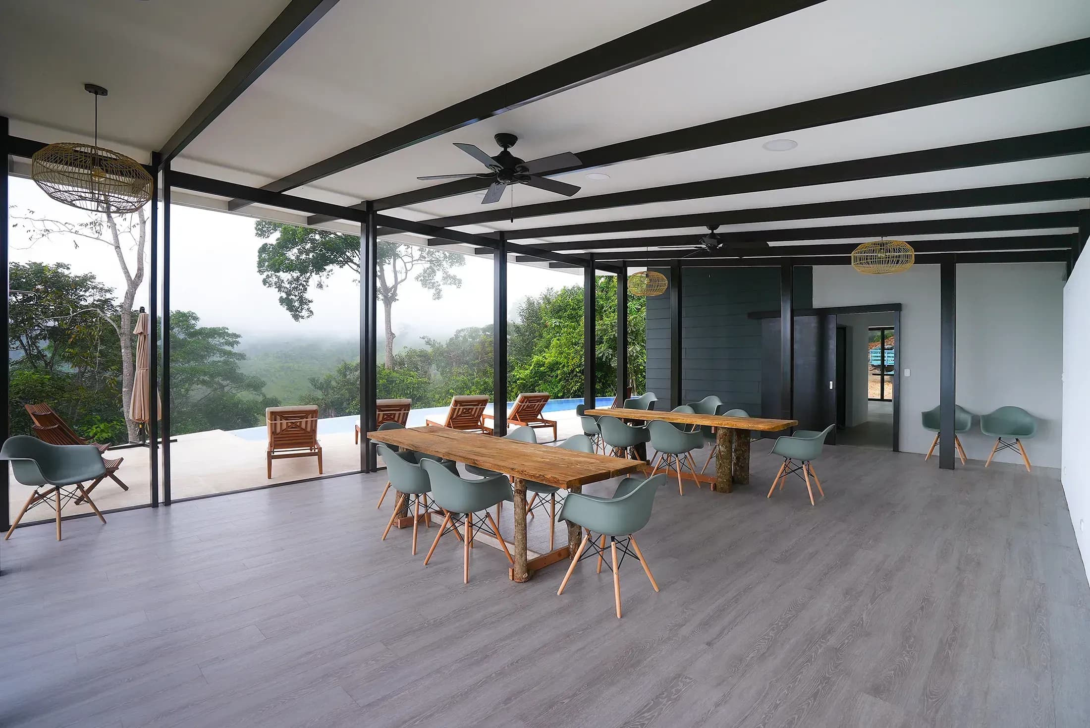 Open-air space with two rectangular tables and 5 chairs around each one. Views of the jungle and Diamante waterfalls.