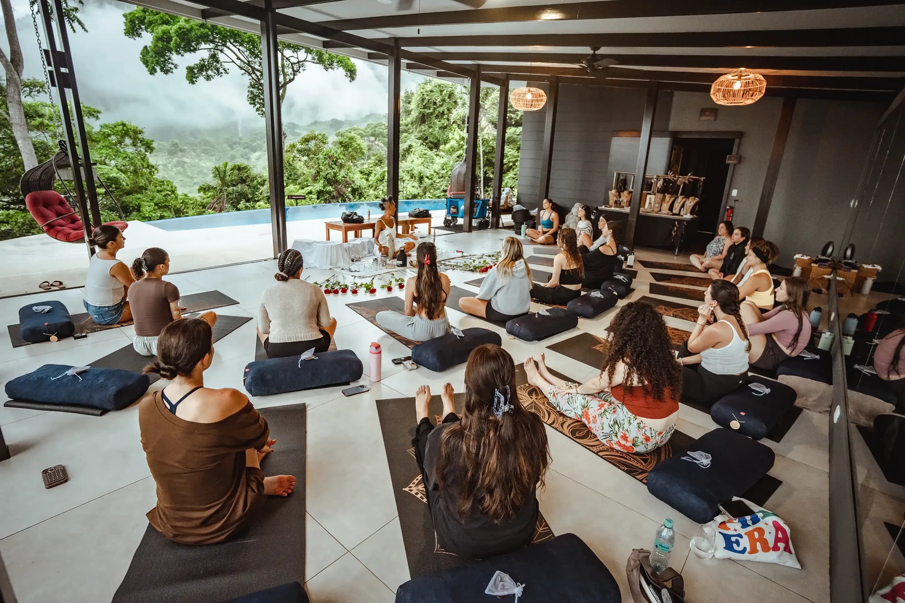 Guests participating in a group meditation session at Vajra Jahra, a Costa Rica Retreat Center surrounded by jungle and mountain views.