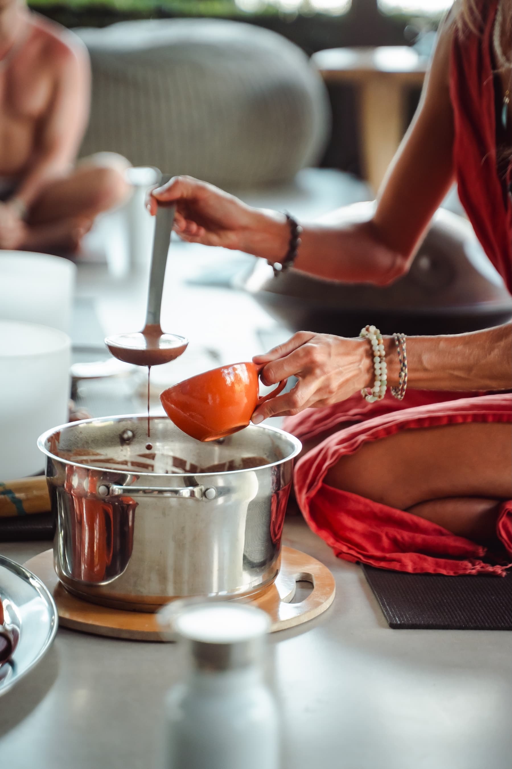 Cacao ceremony facilitator Katya Samana serving a cup of ceremonial cacao at Vajra Jahra Retreat Center in Costa Rica.