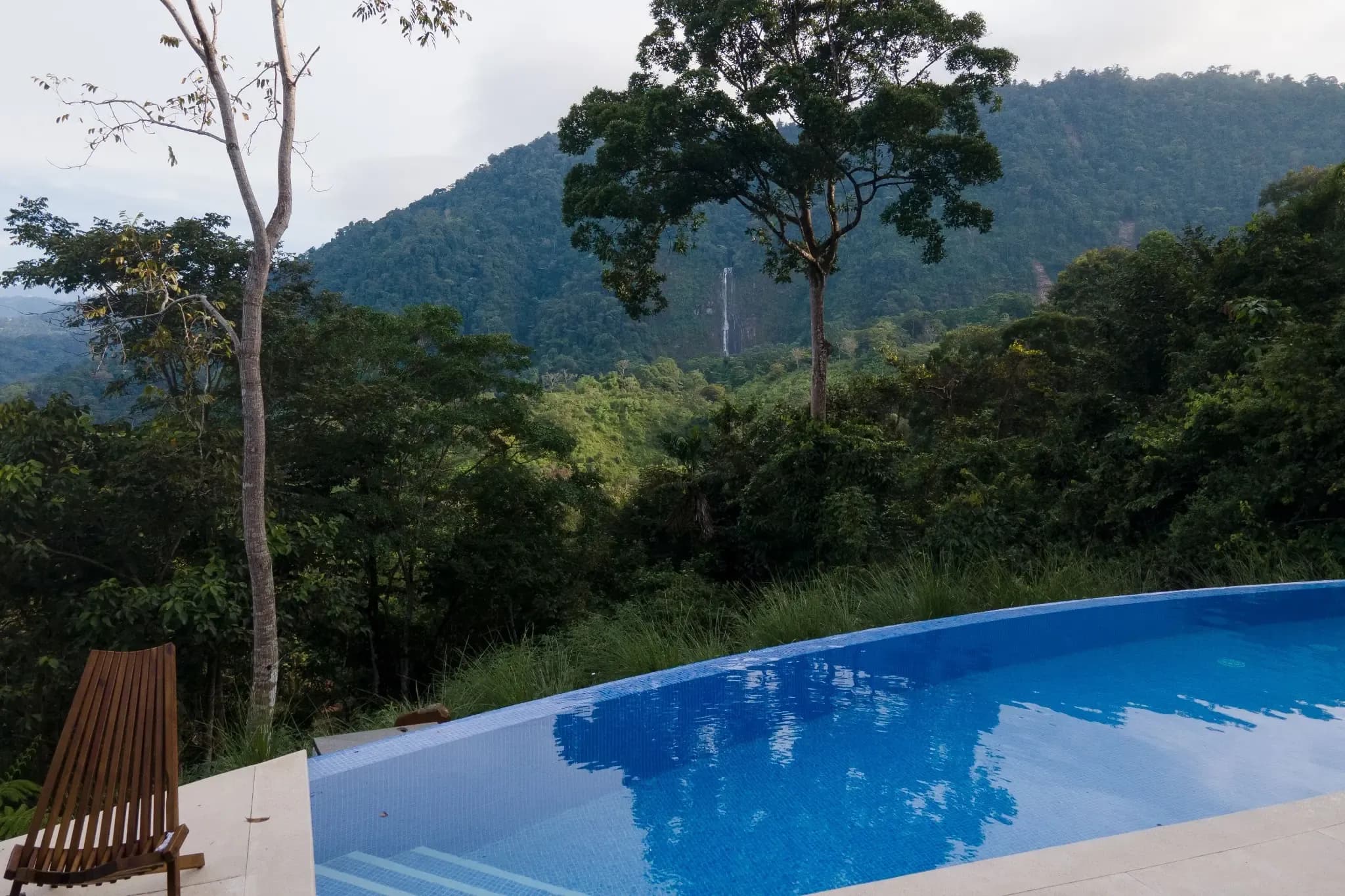 Poolside view of Costa Rica's Diamante Valley from Vajra Jahra Retreat Center, with Diamante Waterfall in the background.