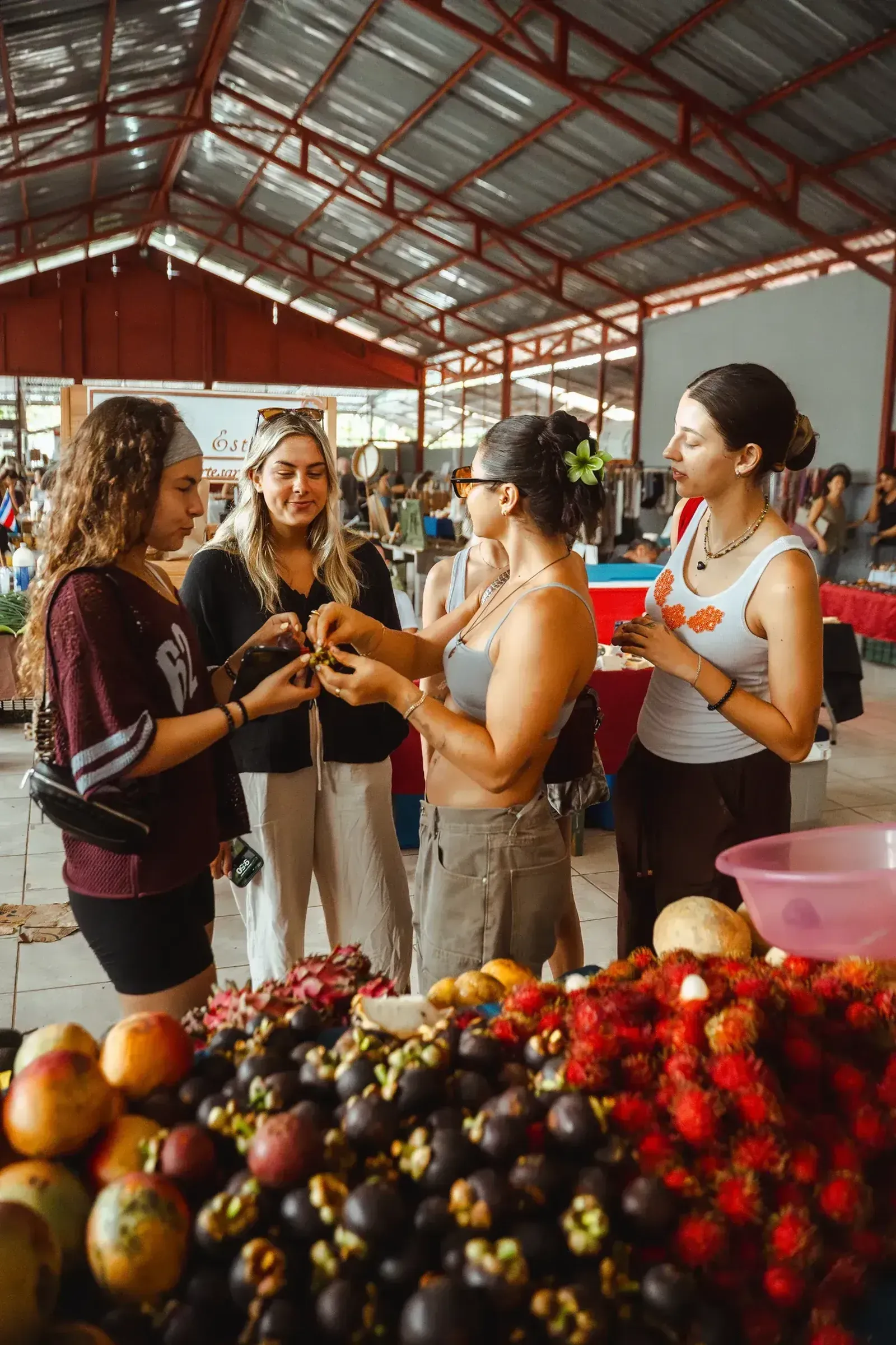 Group enjoying a hands-on cultural experience during a farmers market outing with Vajra Jahra Wellness Retreat Center.
