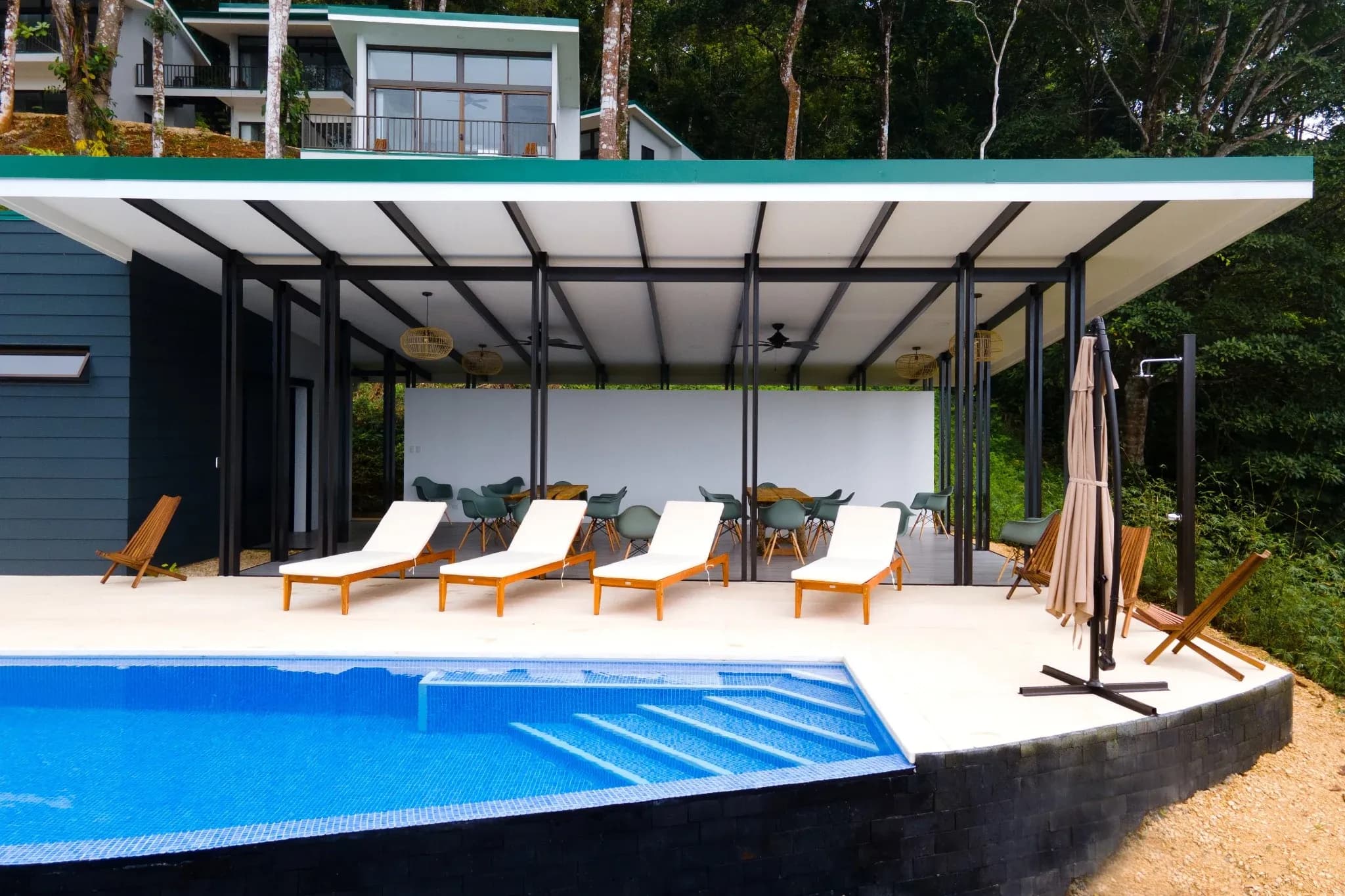 Poolside lounge area with mountain views at Vajra Jahra Retreat Center, a luxurious Corporate Retreat Venue designed for comfort and connection.
