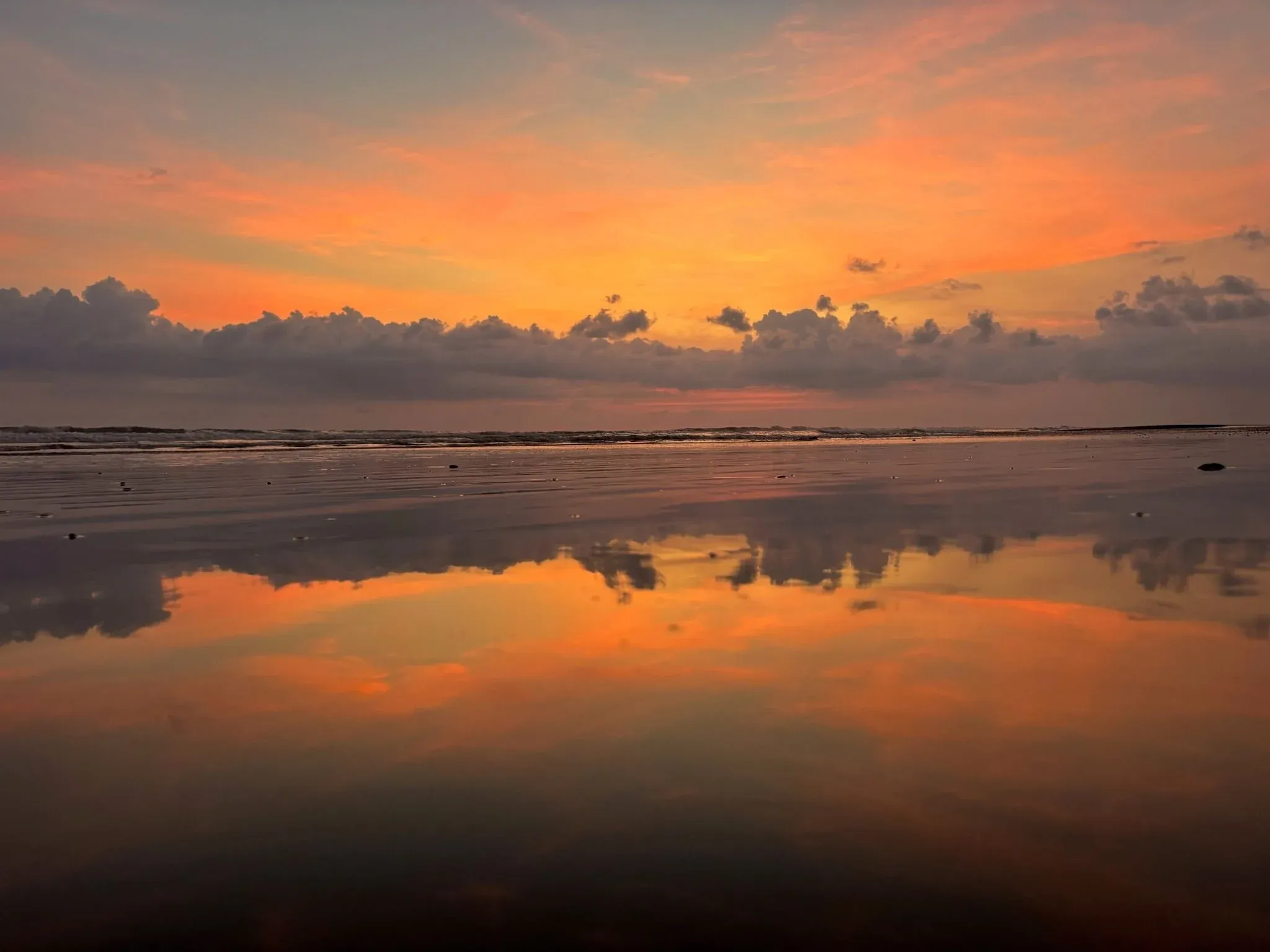 Vibrant sunset reflecting on the calm ocean near Vajra Jahra Retreat Center, capturing the serene beauty of a retreat Costa Rica evening by the beach.