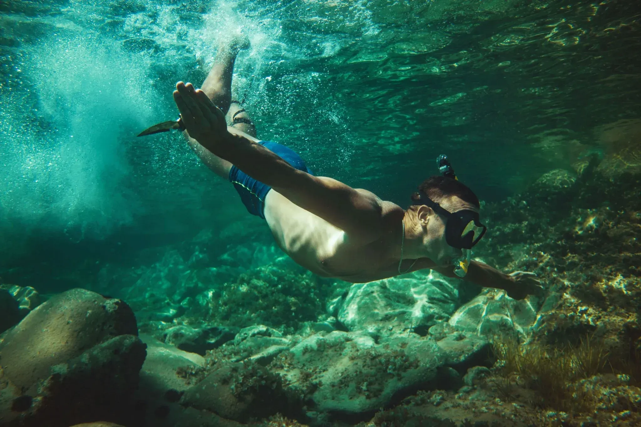 Snorkeler gliding through crystal-clear water near Vajra Jahra Retreat Center, highlighting the natural beauty available when you rent a retreat center.