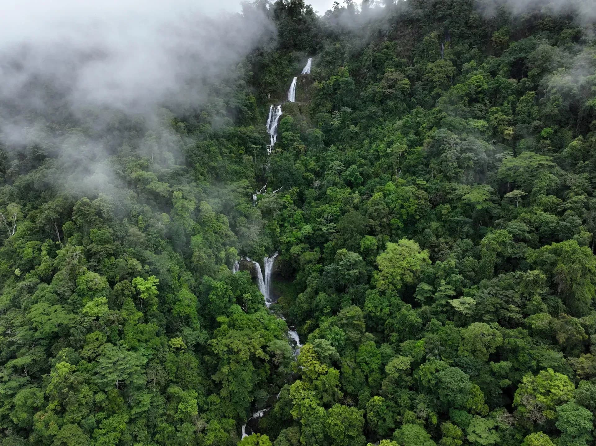 Aerial view of the Diamante Waterfalls surrounded by lush rainforest near Vajra Jahra, a premier wellness retreat center in Costa Rica.