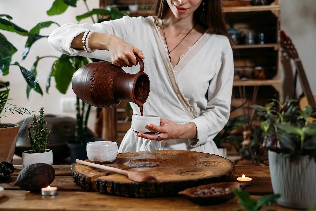 A woman pouring ceremonial-grade cacao into cup teaching benefits of ceremonial cacao