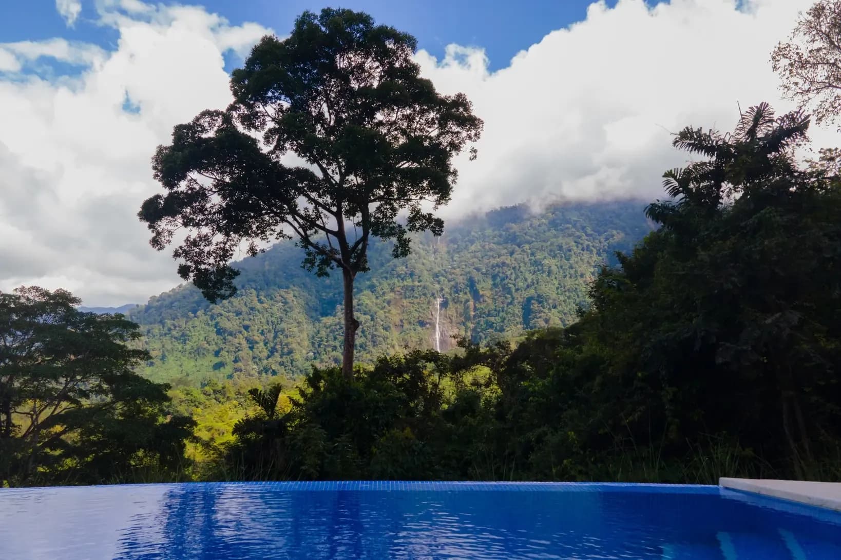 Relaxing poolside view of Costa Rica’s rainforest at the Vajra Jahra Retreat Center, a serene place to Rent a Retreat Center.