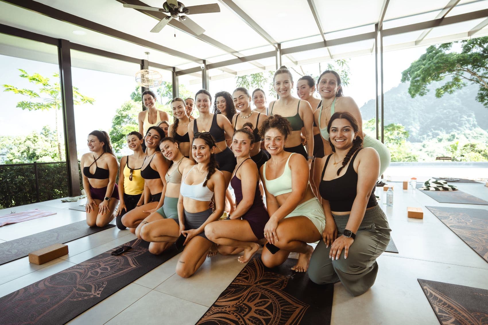 Group of trainees at Vajra Jajra Retreat center smiling after an engaging session of a yoga teacher training course.