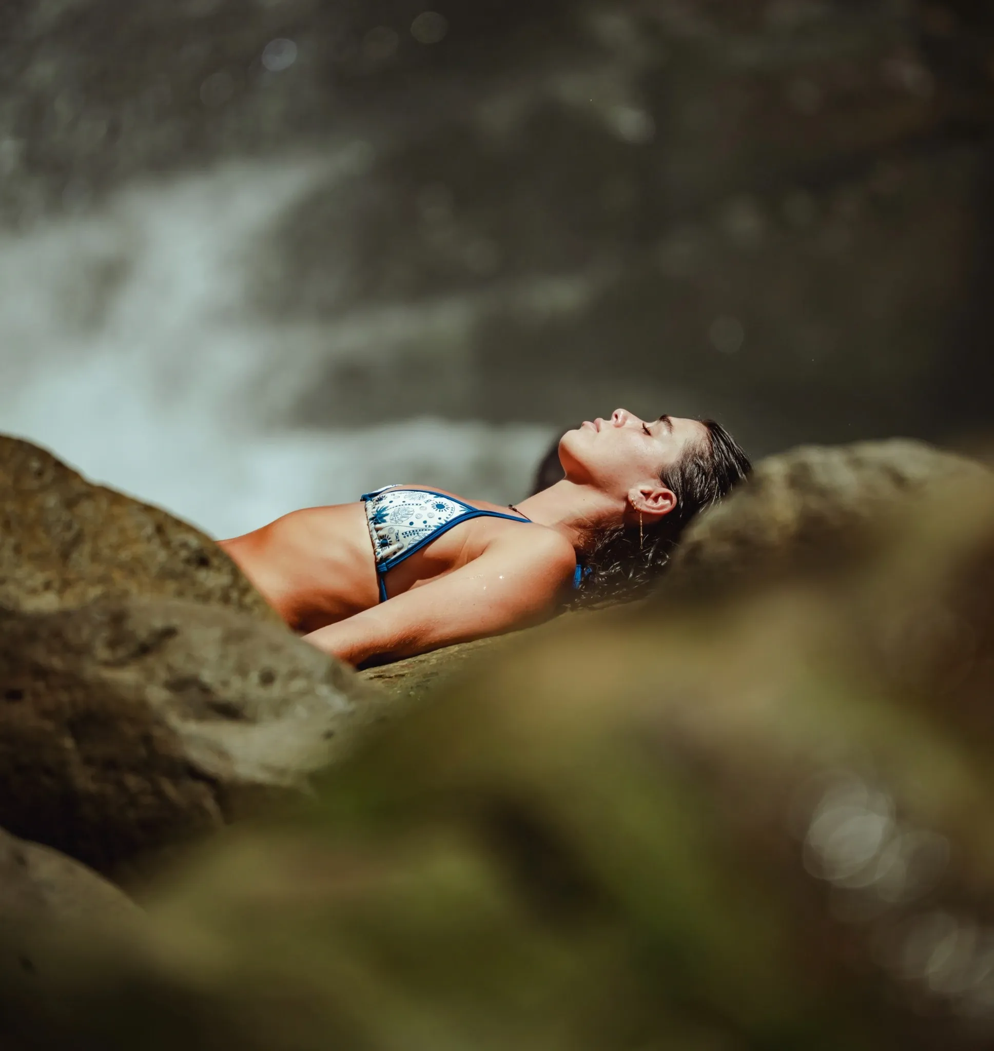 Guest relaxing by a jungle waterfall at Vajra Jahra Retreat Center, part of luxury Airbnb vacation packages in Costa Rica.