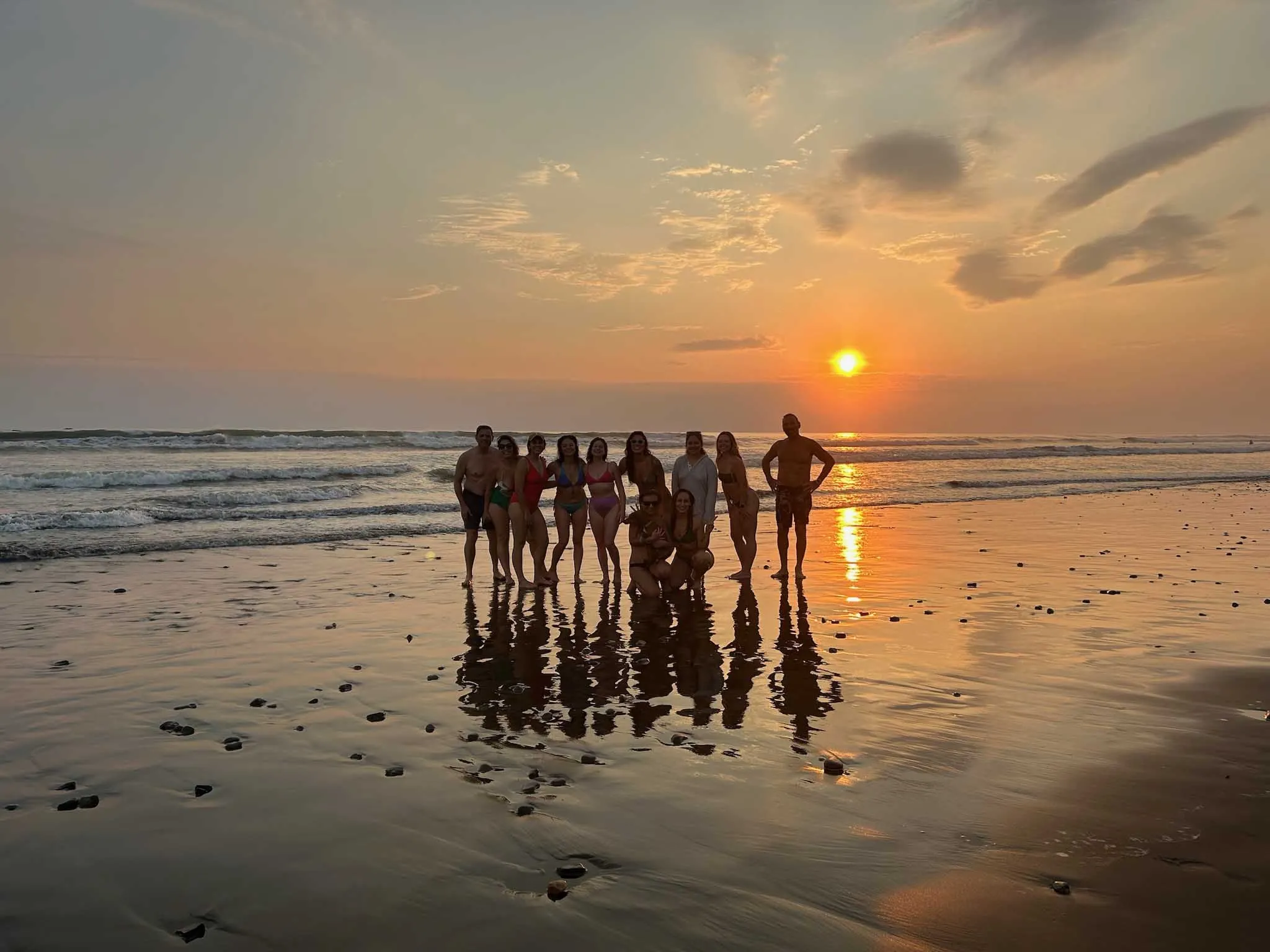 Corporate team bonding during sunset at the beach near Vajra Jahra Retreat Center, a breathtaking Corporate Retreat Venue in Costa Rica.