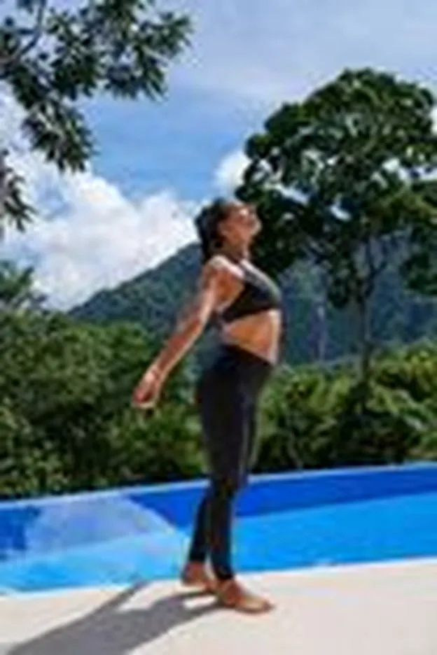 Guest enjoying the outside weather and views on the deck by the pool.